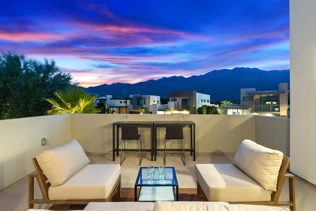 Perfectly positioned in the coveted Vibe community, this rare standalone home combines the ease of maintenance-free condo living with the comfort and privacy of a single-family residence. Step inside this light-filled three-bedroom, three-bath retreat and immediately be greeted by sweeping western views of Mt. San Jacinto. The open-concept layout showcases a chef's dream kitchen with quartz countertops and a seamless flow into the dining and living areas. Retractable folding doors dissolve the boundary between indoors and out, leading to entertainment-ready patios and a tranquil backyard oasis complete with a custom Zen-inspired waterfall. The main-level primary suite is a true sanctuary, featuring a spa-like bathroom and oversized walk-in closet. Also on the main level: a third bedroom, guest bath, and a spacious laundry room for effortless convenience. Upstairs, discover an additional primary ensuite plus a versatile loft--ideal as a media room, home office, or gym--with an oversized balcony boasting breathtaking, panoramic mountain views. Upgrades abound: owned solar, a tankless water heater, an attached two-car garage with frosted glass doors, and ample storage throughout. Beyond the home itself, residents of Vibe enjoy resort-style amenities including a heated pool and spa, expansive sun deck, outdoor clubhouse with grilling station, two dog parks, bocce ball courts, and EV charging stations. This is more than a home--it's a lifestyle.