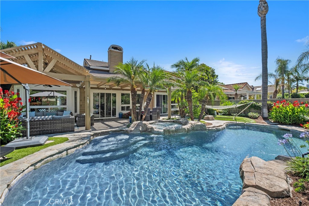 Welcome to 7 Blackburn, a stunning, designer-renovated pool home tucked away on an oversized lot in the exclusive guard-gated community of Dove Canyon. Located at the end of a cul-de-sac, this residence offers exceptional privacy and a truly resort-style backyard designed for year-round enjoyment.
Inside, you're greeted by soaring ceilings, abundant natural light, and a flowing open layout. The main level features a spacious primary suite, marble flooring in the kitchen and family room, and rich hardwood flooring in the dining and living rooms. Every detail has been thoughtfully updated, including dual-pane windows, upgraded recessed lighting, elegant new crystal light fixtures in the entry, dining, and living rooms, plus smart home features like Nest climate control, a Ring doorbell, SimpliSafe security, and remote-controlled interior blinds add modern convenience throughout.
The reimagined kitchen is a showstopper, complete with natural quartzite countertops finished with three waterfall edges, new cabinetry with designer brass hardware, a Viking range, Bosch double ovens and dishwasher, a Kohler farmhouse sink, and a built-in Sub-Zero refrigerator. The adjacent family room and casual dining area overlook the expansive backyard, creating a seamless flow for everyday living and entertaining.
The primary suite offers spa-like relaxation, featuring an oversized soaking tub, dual vanities, tiled walls, and a glass-enclosed shower. Upstairs, three generously sized bedrooms and a fully remodeled bathroom provide plenty of space for family or guests.
Outside you’ll find a private oasis with a saltwater PebbleTec pool and spa w/ Baja entry, surrounded by professionally designed landscaping with mature trees, plus and outdoor kitchen featuring a Sunfire BBQ & cooktop. A Sunbrite outdoor TV, Infratech heating units, and remote-controlled lighting with multiple color options and privacy shades create the perfect setup for entertaining in any season. Additional highlights include a lighted putting green and chipping area, artificial turf in the front and back yards, a covered gazebo, and a portable outdoor shower. The garage is complete with epoxy floors, built-in cabinets and a new LiftMaster quiet garage opener. This is more than a home…it’s a refined retreat where every detail has been elevated to offer the best in luxury, comfort, and California living.