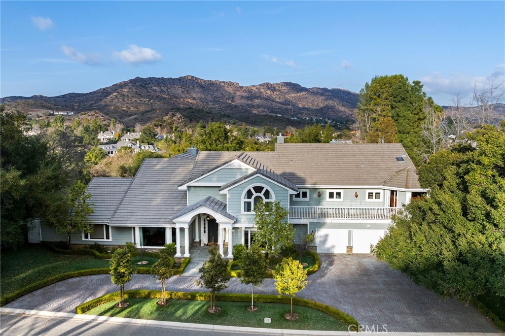 Nestled in the highly sought-after North Ranch Estates of Westlake Village, this magnificent estate offers over 7,000 sq. ft. of exceptional living space on a sprawling half-acre+ lot. Designed for luxury, comfort, and entertainment, this home boasts 5 en-suite bedrooms, 6 bathrooms, and an array of premium amenities.
Step inside to discover an elegant media room, a dedicated home office, and a private gym complete with a dry sauna. The gourmet kitchen is a chef’s dream, featuring custom inset cabinetry with pull-out drawers, Sub-Zero, Wolf, and Viking appliances, and a temperature-controlled wine cellar that accommodates approximately 1,000 bottles.
The upper level showcases four en-suite bedrooms, and 4 balconies. The primary suite is a true retreat, offering a private seating area, soaring vaulted ceilings, two custom closets, and a spa-like bathroom with a full-body shower and wet sauna.
Outdoors, the professionally landscaped front yard welcomes you with a grand horseshoe driveway leading to a three-car garage equipped with two 220V plugs for electric vehicles. The resort-style backyard is designed for ultimate entertainment, featuring three expansive seating areas, a fire pit, an outdoor fireplace, a putting green, and a fully equipped outdoor kitchen with an oversized BBQ, Green Egg smoker, and seating for eight.
This exceptional residence embodies luxury living at its finest, blending elegant design with modern amenities in one of Westlake Village’s most prestigious communities.