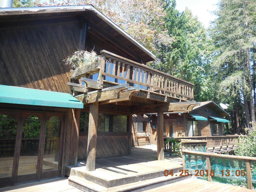 New Reduced Price as of 1/16/2019. 3 separate buildings, 4 living areas. Fantastic potential in this executive mansion in a redwood forest. This property is crying out to be brought back to its fabulous prior condition, with extensive tropical gardens. The property consists of 3 buildings, all of expensive wood, with a garage / barn / workshop next to the road, the main house down a path and a separate guest house - all on nearly 3 acres. Surrounded by redwoods, this would make a beautiful escape from the Silicon Valley.