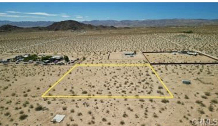 PAID WATER METER Lot, in north Joshua tree. Great opportunity to build in Joshua Tree on this 2.5-acre lot. Make your dream desert home a reality! Unique plants on this lot will great a classic desert landscape for your new build. Very hard to find a lot with all utilities and a paid water meter ready to build on. Very expansive views, just off the paved road of Border near Winters Rd.