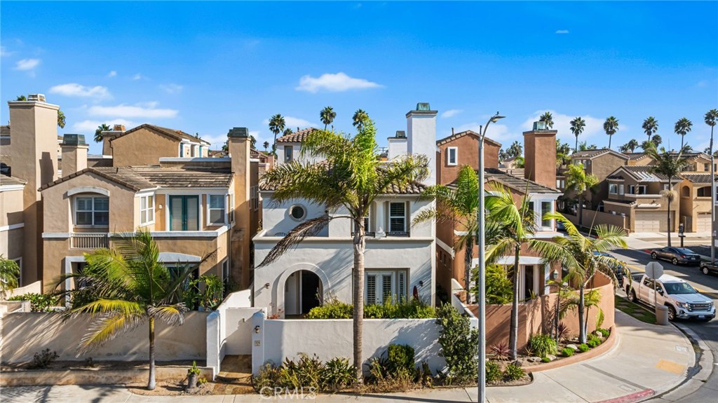 Experience the best of coastal luxury in this stunning, completely remodeled Downtown Huntington Beach residence, offering nearly 3,100 square feet of sophisticated living just moments from the sand, pier, and vibrant Main Street. Designed with elegance and functionality in mind, this spacious home features 3 bedrooms plus a bonus room (easily converted to 4th bedroom), 3.5 baths, and a modern open-concept layout ideal for both entertaining and everyday comfort. The inviting main level welcomes you with expansive living and dining areas highlighted by floor-to-ceiling stone fireplaces and rich designer finishes throughout. The chef-inspired kitchen that is open to the family room is a true showpiece, complete with premium stainless steel appliances, a convenient pot filler above the range, sleek quartz countertops, a large walk-in pantry and a generous center island with seating perfect for gathering. Step outside to the center courtyard, featuring a beautiful fountain and a built-in BBQ center, creating an ideal space for outdoor entertaining. Upstairs, the luxurious primary suite offers a serene retreat with its own fireplace, private balcony, and a spa-like bathroom featuring dual sinks, a soaking tub, and a walk-in shower. Two additional bedrooms and a spacious bonus room provide ample flexibility for guests, a home office, or media space. The third level features an impressive rooftop deck with a view of the ocean, the perfect spot to enjoy sunsets and sea breezes. Additional highlights include a main-level powder room, custom lighting, luxury flooring throughout, new dual pane windows, central AC and an attached two-car garage with direct access. Blending contemporary design with the relaxed charm of beachside living, this home offers the ultimate Huntington Beach lifestyle, just blocks from world-class shopping, dining, and the iconic coastline.