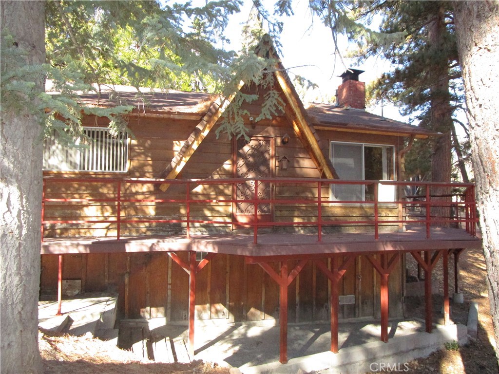 RARE FIND SINGLE LEVEL HOME ON 5 LOTS!!!! This cute & cozy home is sitting on 3 of the 5 lots with the other TWO remaining LOTS VACANT & ready to possibly build another home, ADU, large garage/storage area-or, just keep it open for the nice open view & area for sledding! The home has 2 good sized bedrooms and 2 baths, laundry room, HUGE open living area with a large brick wood burning fireplace to enjoy on those snowy winter nights! Kitchen with a breakfast bar and a separate dining area. One of the bedrooms has it's own entry & private space away from main area of the home. Another rarity is this home has a 2 car garage and parking for 2+ cars! Awesome location close to the "Children's Forest", walking distance to Arrowbear Park & a small lake. A small quaint town, yet just approx. 4 miles to Snow Valley Mountain Resort! Centrally located between Big Bear and Lake Arrowhead. With the extra 2 lots, your options are ENDLESS!! "Serviced Roads" with Trash pick up, Snow plows, street sweepers. Beautiful in the Winter & Summers!!! Purchase your cozy WINTER CABIN before the season comes...