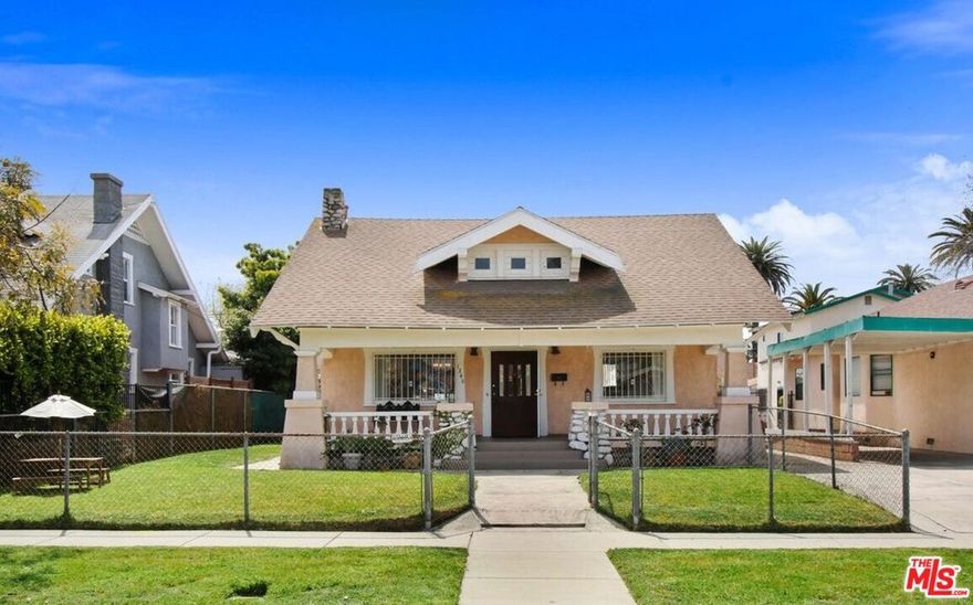 This charming 4 bedroom and 2 bath craftsman home is located one block from the historic Carnegie Library and beautiful Vermont Square Park. The home has wonderful original craftsman detail. The living room and dining room have high vaulted ceilings and large windows that bring in terrific natural light. There is a classic front sitting porch and yard for hanging out and sipping iced tea, and a large back yard with a fruit bearing tangerine tree. The kitchen is spacious with an adjacent laundry room. There is central heat and air conditioning. The attic is quite large with windows, and seems to have been created as an option to have a second story living space (buyer would need to verify possibility independently). The home is located close to local schools, just over one mile from the L.A. Coliseum, University of Southern California, Exhibition Park Stadium, 3 miles from downtown Los Angeles, and only 10 miles to beautiful beaches and the Los Angeles International Airport.