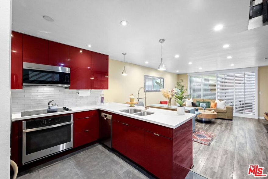 Welcome to 5951 Canterbury Drive #20, a rare corner end-unit in the highly desirable Los Cerros Townhomes of Culver City. This beautifully remodeled two-story townhouse offers 2 bedrooms and 2 bathrooms with no neighbors above or below with only one common wall, blending privacy with comfort. The open-concept layout features engineered hardwood floors, recessed lighting, a ceramic electric fireplace with a pull-out TV unit, and a seamless flow between the living, dining, and kitchen areas. A sliding glass door opens to a private patio, perfect for enjoying fresh air and al fresco dining. The fully updated kitchen boasts high-gloss lacquered cabinetry, quartz countertops, ceramic tile flooring, and stainless steel appliances including a refrigerator, microwave, dishwasher, and drop-in oven with stovetop. Upstairs, both bedrooms are spacious and filled with natural light, complemented by energy-efficient windows and modern remodeled bathrooms. Additional highlights include custom wooden railings, new plumbing, a tankless water heater, alarm system, and two side-by-side parking spaces with storage in the secured underground garage. Enjoy community amenities like a heated pool and easy access to Culver City's best dining, shopping, and entertainment all while tucked away in a peaceful, well-maintained neighborhood.