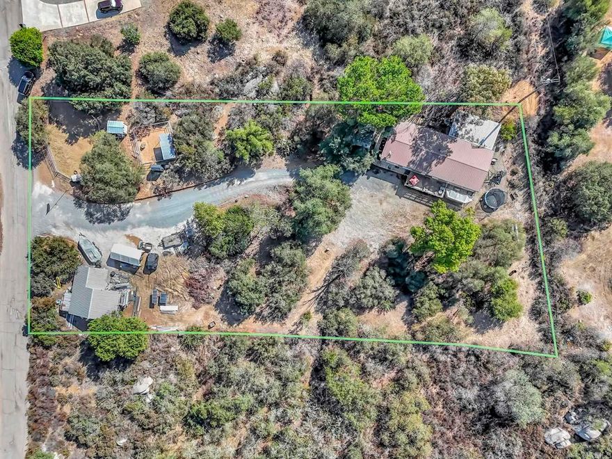 Are you looking for a beautiful piece of property located in a private location but very close to town? Look no further, as this magnificent 1.33 acre property with beautiful manzanita trees, boulders and a serene feel is waiting for you! The property also offers two horse corrals with a tack shed! Detached large shop with a one car garage! Hidden and tucked away off the private street of Lilac Ranch Rd. is a gorgeous 3 bedroom with a den (optional 4th bedroom), 2 full bathroom family home. Walk into this beauty and admire gorgeous wood flooring throughout most of the home. Enjoy a large living room and a separate dining area with beautiful newer carpet. A nice size kitchen that opens up to a family room - ideal for entertaining while cooking. Large Primary Bedroom located on opposite side of house that offers massive closet space and a private primary bathroom. The primary bathroom offers a large separate tub and shower. Down the hall is two more bedrooms and a den (optional 4th bedroom). The hallway bathroom has been updated with new fixtures. Large laundry room with sink and area to fold/hang clothes. Walk out the back door onto a covered patio area - great for barbecuing or entertaining. The front porch offers an area to relax and drink coffee while soaking in the tranquility and peace this beautiful property offers. Take in the magnificent sunset while relaxing on the porch. The shop/garage offers 700 square feet with fully powered 1000 watts of solar panels charging a 24 volt battery system. The batteries run the 4000 watt pure sine inverter. 8000 watt surge power system will run lights, garage door opener, tools, refrigerator, tv, etc. Plenty of room for a trailer, RV, boat & more! Close to shopping, schools & more!