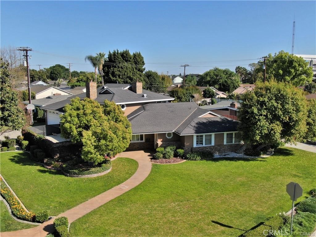 Nestled in one of North Whittier's most exclusive neighborhoods, this magnificent corner lot estate showcases a beautifully appointed interior. The estate features a spacious floorplan, complete with a well-equipped chef's kitchen, lots of storage in garage and attic, attic fan, two water heaters and two a/c condensers for convenience,premium built-in appliances, two primary suites, a newly plastered saltwater pool and jacuzzi, highlighted by serene waterfalls and ambient lighting. Additional features include two driveways, ample onsite parking, and a sprawling front lawn with lush greenery and a 180-degree vantage view. Recent upgrades include an elegant exterior and interior color palette, as well as a stacked stone front façade. The functional floorplan makes this home an ideal option for multi-generational use. The second level serves as a private retreat, complete with a primary ensuite bathroom, featuring a his and hers sink, separate tub and shower enclosure, custom walk-in closet, and vanity table. With a Walk Score of 77, the home's proximity to Whittwood Center, Amazon Fresh, restaurants, hiking trails, and more makes it a truly exclusive residence.