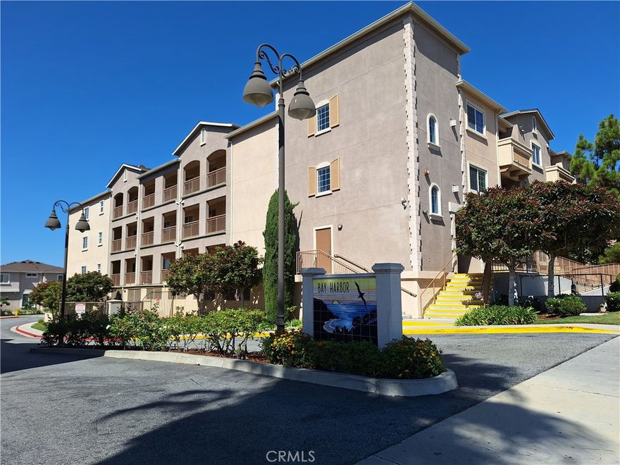 Experience luxury living in the gated Bay Harbor community with this bright and open 3-bed, 2-bath end unit condo featuring laminate floors throughout, a gourmet kitchen with granite countertops, stainless steel appliances, a cozy living room fireplace, a master suite with a walk-in closet, and a private balcony with direct access to BBQ units in the courtyard. Enjoy convenient access to shopping, dining, the 110 FWY, and two assigned tandem parking spaces in this secure, amenity-rich complex.