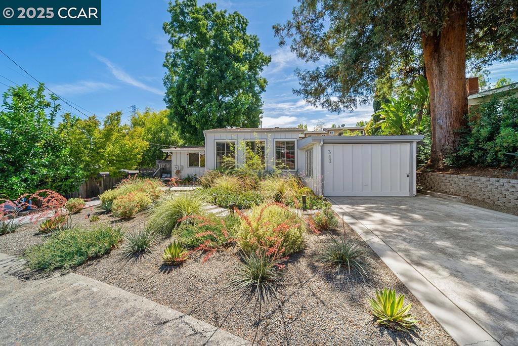 Charming Martinez Retreat with tons of Natural Light! This light-filled 3-bed, 2-bath home blends comfort, style, and convenience. Move-in ready finishes include a chef’s kitchen with modern appliances, hardwood floor and quartz countertops — this home is ideal for both everyday living and entertaining. The spacious primary bedroom offers ample closet space and an ensuite bath with a dual vanity. Two additional bedrooms and a remodeled guest bath is perfect for visitors. The professionally designed, water-wise front yard — crafted by the experts at Ruth Bancroft Gardens — provides year-round beauty with minimal maintenance. Relax in the rear yard on the wraparound deck or enjoy gardening in the raised beds. Whether you’re starting a family or looking to downsize, you’ll love the easy-flow layout and welcoming vibe. Convenient location near Muir Station Shopping Center with shopping, dining, movie theater, freeway access and more!