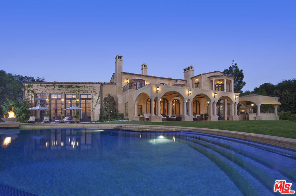 Incredible New Price!!! This exquisite European Villa located within the prestigious guard-gated enclave of Beverly Ridge Estates is a delicate combination of stunning architectural design and dramatic scale! Situated on approximately two acres of land, gorgeous sunsets serve as the perfect backdrop to the infinity-edge pool, floating sky deck and stunning canyon views. This tranquil setting is surrounded by sprawling lush landscape, mature fruit trees with vistas of green from every room inspiring a seamless transition within your own private oasis including pool, spa, open cabana, outdoor kitchen & BBQ area. The main floor of the estate is designed for entertaining & features a striking grand entry with hand carved wood-paneled ceiling, a Great Room with soaring ceilings, beautiful stone fireplace, reclaimed barn wood beams, open Living Room, Formal Dining Room, Wet bar, Gourmet Kitchen, Wine Room, Gym, Theater and beautifully appointed Family Room. The design features contemporary finishes & luxurious elements such as antique doors imported from Spain, onyx countertops, handcrafted cabinets, imported Moroccan tiles, and reclaimed barn wood flooring from Stoddard, New Hampshire. The Master suite with private office and terrace overlook this idyllic and serene setting. A rare opportunity for privacy, security and a lifestyle that one can only dream of!