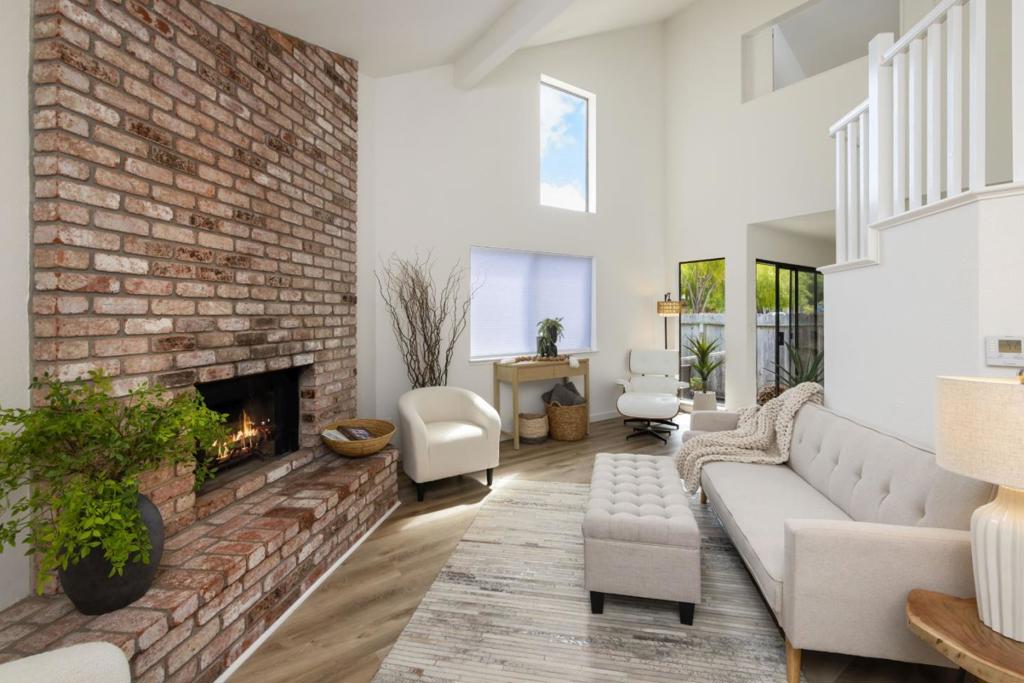 Tucked away in a prime Capitola location, perfectly positioned between the charm of Capitola Village and the energy of 41st Avenue, 1901 Courtyard #D is a freshly updated and inviting 2-bedroom, 1.5-bath townhome with 1,122 sq. ft. of light-filled living. Recent upgrades include new flooring & carpet, fresh interior paint,a new refrigerator, new toilets, new furnace (2024), and an epoxy garage floor. The living room boasts soaring ceilings, abundant natural light, and a wood-burning fireplace. The dining area flows seamlessly to a private ground-level patio ideal for morning coffee or evening gatherings. Upstairs, the spacious primary suite features vaulted ceilings, a private balcony, and a walk-in closet. One-car garage with driveway parking, & a lush grassy common area for all residents to enjoy. The HOA covers water, garbage, sewer, fire insurance, and more, making for effortless living. Courtyard Commons captures the quintessential Santa Cruz lifestyle with a WALKABILITY SCORE OF 10 - stroll or bike to Capitola Esplanade for year-round entertainment, Pleasure Point for world-class surfing, and 41st Avenue for dining, shopping, and nightlife. Whether you're seeking a full-time home or the perfect coastal getaway, this townhome delivers the best of Capitola living.