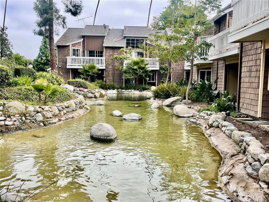 Gorgeous 1bdrm/1ba upstairs condo featuring vaulted ceilings and abundant natural light! This open-concept floor plan offers a modern kitchen with granite countertops, stainless steel appliances, and vinyl flooring throughout. Enjoy peaceful views overlooking the community stream and relax on your private balcony complete with washer/dryer. Includes a 2-car detached garage and access to a sparkling community pool in this gated community.