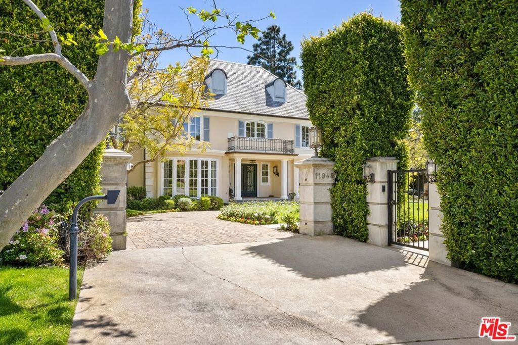 Situated in one of Brentwood's most coveted neighborhoods, 11948 Chaparal Street is an exquisite estate that seamlessly combines timeless elegance with modern California living. This 7,500-square-foot home offers 5 spacious bedrooms, 6.5 luxurious bathrooms, and an expansive layout that's perfect for both relaxation and entertaining. The grand entryway leads to bright, open living spaces with soaring ceilings, intricate millwork, and a seamless flow between formal and casual rooms. The chef's kitchen is equipped with top-of-the-line appliances, a large center island, and direct access to the family room and outdoor spaces, creating the perfect setting for both everyday living and large gatherings. Step outside and discover your very own private oasis: a full-size tennis court, a sprawling grassy lawn, a sparkling pool and spa, and multiple lounging areas framed by lush, mature landscaping. Whether hosting guests or relaxing in solitude, this outdoor retreat is a dream come true. The expansive second floor is home to a stunning primary suite featuring dual walk-in closets, a spa-like bathroom, and a private balcony with serene views of the grounds, the ocean, and the iconic Queen's Necklace. Each additional bedroom is generously sized and comes with its own en-suite bathroom and ample closet space. Perfectly situated just moments from the Brentwood Country Mart, known for its charming shops, cafes, and weekend markets, and only a short distance from St. Martin of Tours School and Brentwood School's West Campus, this home offers the ultimate in luxury living, location, and lifestyle.