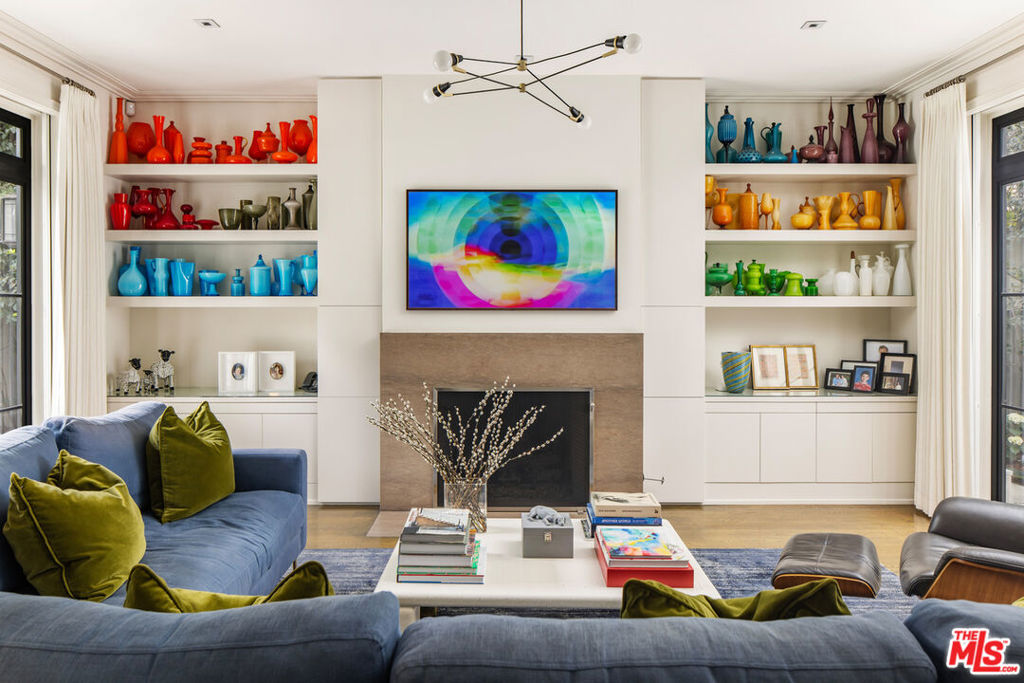 Originally designed by William Hefner and subsequently reimagined by renowned interior designer Sally Breer, this light-filled contemporary Mediterranean residence delivers modern amenities while retaining the architectural details and pedigree of Hancock Park. Hefner's style is known for its classic proportions and elegance, and that's accomplished here in this 7,500 square foot chic smart-home. It's modern, yet traditional and lively. Ideal for the display of a collection of art, the main level features an iconic study, formal living and dining rooms, all of which converge upon a central outdoor courtyard. The family room and breakfast nook spill outside to the salt-water pool and outdoor dining area. The kitchen is adorned with three dishwashers, three ovens, and two ranges. A separate butler's kitchen accommodates the Kosher chef or can easily be converted to wine storage. An elevator ride upstairs leads to five generously sized bedrooms, each with their own ensuite bathroom and walk-in closet. The primary suite is decorated with vaulted ceilings, a balcony, and has a jetted tub, giant walk-in closet, and dual-vanity. The lower level consists of a large home-theater, multiple flex spaces and storage areas, an office, gym, and automobile turntable which accommodates parking for three cars. Other amenities include: Six HVAC zones, Missoni carpet and wallpaper, mature landscaping, fiber-optic and CCTV wiring, roman shades, black-out curtains, water-softening, and smart lighting. All this, only minutes to Larchmont Village, the Sycamore District, and world class art galleries, dining and shopping. Can be delivered furnished.