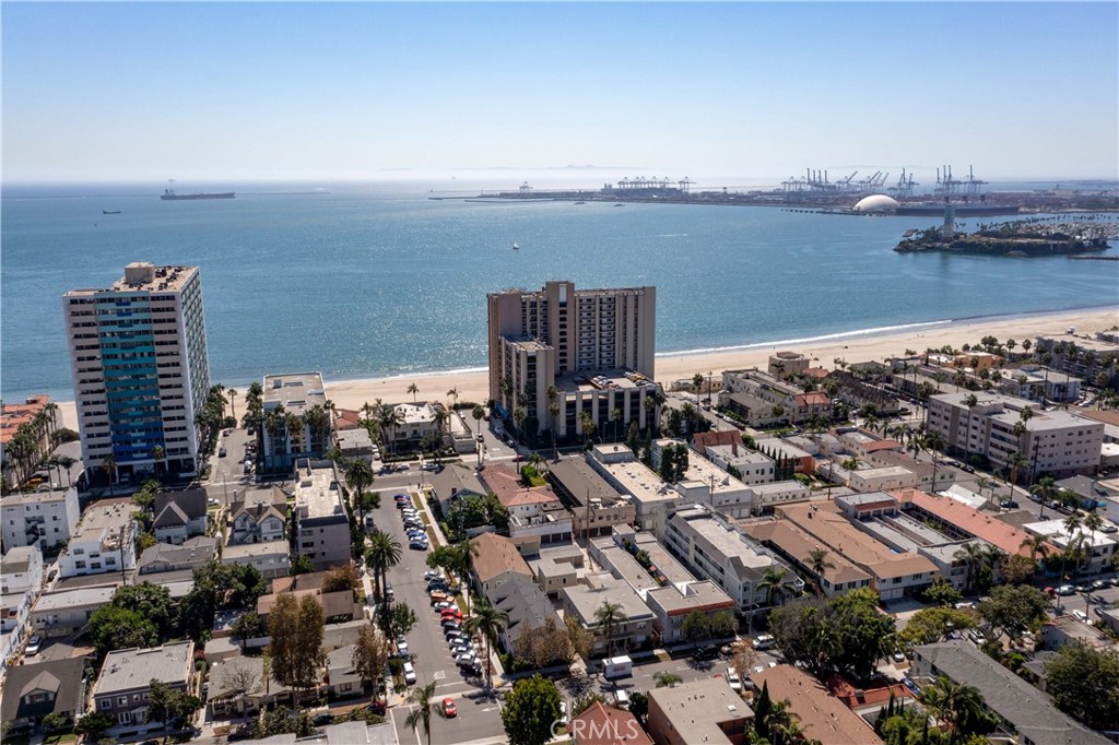 Welcome to your seaside oasis! Nestled along the Pacific coastline, this updated condo with amazing side ocean views invites you to experience coastal living. Step inside and be greeted by an open concept layout, where the living, dining, and kitchen areas seamlessly flow together, creating an ideal space for comfortable living and simply relaxing in style. Floor to ceiling windows capture the ocean views and abundant natural light. Take in the serene ocean vistas on your private balcony, perfect for enjoying morning coffee or alfresco dining. You'll enjoy practicing your culinary skills in the kitchen, with newer appliances, modern cabinetry, quartz countertops and breakfast bar, perfect for both cooking enthusiasts or casual meal prep. The bedroom features ocean views, creating a tranquil retreat to relax. Comfort adds to convenience with central heat and ac, in-unit laundry and a parking space with storage cabinets. Step outside your abode to embrace beachfront living with direct beach and walking path access, biking and exercise, or seaside strolls. The Queen's Surf offers a resort-style experience with a saltwater pool, perfect for basking in the sun or unwinding with a refreshing dip. Additional amenities include a jacuzzi, sauna, clubhouse, fitness center, and spacious ocean view deck for relaxation and socializing. The HOA fee includes Internet, WIFI, Cable TV, and water. A prime location between popular Belmont Shore and downtown, you're also minutes to the Pike, Pine Ave, Bixby Park, and the Farmer's market, with many opportunities for shopping and recreation. Don't miss your chance to make this charming retreat your own. Schedule a viewing today and prepare to be captivated by coastal living at its finest!