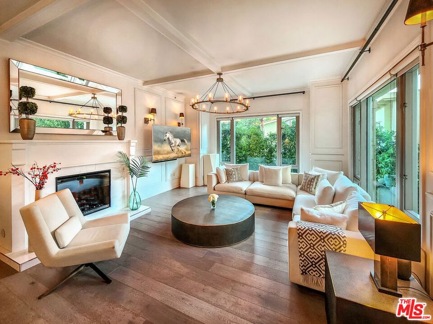 Located in one of the most prestigious high-rise residences along the Wilshire Corridor, this impeccably renovated New York style home offers a rare opportunity to experience the sophistication and prestige of The Remington. A private elevator opens directly into the formal entry of this highly sought-after north-facing residence, where an expansive 1,775-square-foot open floor plan awaits. Designed by Close Design, the interiors blend contemporary elegance with the essence of modern city living. This two-bedroom, two-and-a-half-bath residence is bathed in natural light, with floor-to-ceiling windows framing serene views of lush greenery and the beautifully landscaped courtyard. The impressive foyer leads to a bright and airy living and dining area featuring wide-plank hardwood floors and a sleek fireplace. The gourmet kitchen is a chef's dream, showcasing marble countertops, a subway tile backsplash, top-of-the-line appliances, a built-in breakfast nook, and a breakfast bar. The luxurious primary suite evokes the feel of a five-star Parisian hotel, complete with a spacious walk-in closet and a spa-inspired marble bath with dual sinks, a soaking tub, and a separate shower. The secondary en-suite bedroom offers flexibility as a guest room, office, or art studio. Additional highlights include custom wood-paneled walls and cabinetry, brass lighting fixtures and finishes, high ceilings, a Miele washer and dryer, a service entrance, a private storage room, and a temperature-controlled wine locker. Residents of The Remington enjoy unparalleled amenities including 24/7 valet and concierge service, a state-of-the-art fitness center with towel and water service, a serene library, a private salon with catering kitchen, a card room, a sun deck with cabanas and lounges, and a heated saltwater lap pool. An unmatched blend of timeless luxury, comfort, and sophistication  this is Wilshire Corridor living at its finest.