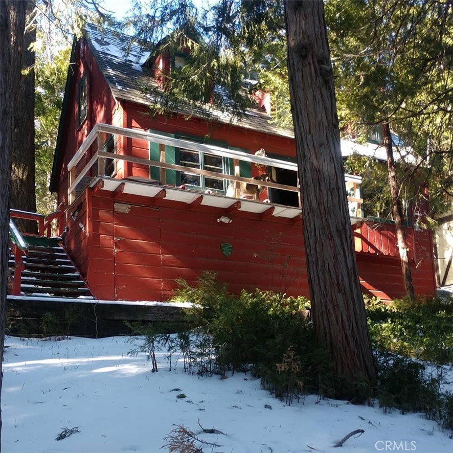 Classic Lake Arrowhead mountain cabin, short distance to shops and restaurants in downtown Cedar Glen and short drive from the lake. Historic 1930’s cedar-plank gabled cabin features two bedrooms, bath, country kitchen, and cozy family room centered around wood-burning fireplace. Interior features rustic cedarwood paneling and cabinetry, furnished throughout in timeless mountain aesthetic. Property includes wooded lot with new deck, barbecue, and fenced back yard for private outdoor entertaining. Storage cellar under house, parking spaces off-street. Proximity to Palisades Point, Lake Arrowhead Village, and other popular lake attractions. This is a rare opportunity to acquire an original vacation home from the golden age of Arrowhead.