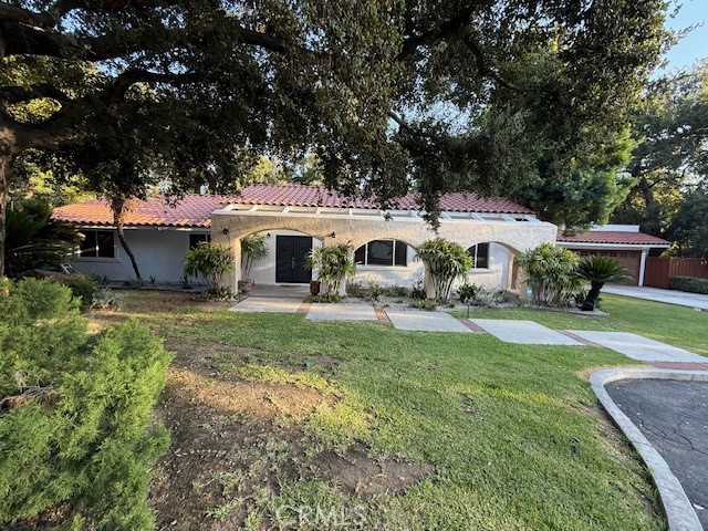Location, location, location. Property features with 4 bedrooms and 3 baths with 2 master suites with a flat lot which has lot size of 14,800 sq ft with single level. This property locates at the top end of the road, and you can enjoy and discover Serenity and Elegance in Monrovia Foothills. Do not miss this excellent value and the chance to own this home! This is an incredible opportunity to own an exceptionally valued home in one of Monrovia's most serene neighborhoods. Nestled in a tranquil and picturesque setting, this exquisite single story Spanish style home is a true gem. Set on a large, beautifully landscaped lot adorned with majestic oak trees, pines, and a variety fruit trees, this property offers an idyllic retreat. The flat backyard provides ample space for a pool or addition of an ADU. A custom made rustic solid oak double door entry welcomes you into this renovated home, which features on open floor plan designed to impress. The residence boasts four spacious bedrooms and three full bathrooms. The property has been totally remodeled inside out with new paint, new bathrooms, new kitchens, new tiles, kitchen cabinets and appliances. Spacious living and dining rooms and open kitchen, with its walls of windows, provides beautiful view of the front garden area and the majestic mountain views, seamlessly blending the beauty of nature into the home. This serene atmosphere makes the space both calming and inspiring. The open kitchen is a chef's dream, showcasing brand new and modern multi-functions' cabinets a large island, and a cozy breakfast nook area. The spacious living room, complete with a fireplace, is the perfect space to unwind and connect after a long day. The gorgeous and modern dining area with beautiful lighting provides a very nice dining area for family. Its openness to the beautiful backyard creates a seamless indoor-outdoor flow that will instantly relax and rejuvenate you. Also, spacious master suite featuring sound reducing wood like wall coverings and it has the brand-new bathroom and has direct access to the back yard. Outdoor living is equally impressive, with a newly built stainless steel grill island, a jacuzzi, and multiple sitting areas. The deck above the garage offers a stunning vantage point to enjoy city lights and starry nights..