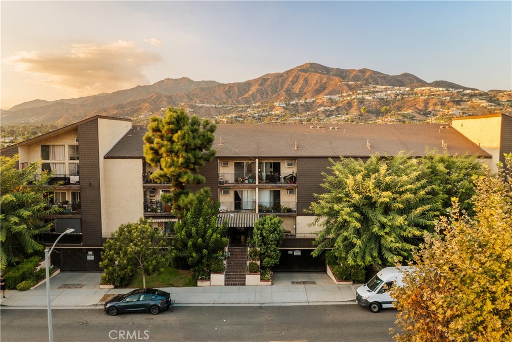 Experience the best of Glendale living in this move-in ready top-floor condominium. Vaulted ceilings and warm wood-tone flooring create a bright, open ambiance, while the spacious living area extends seamlessly to a covered balcony—perfect for morning coffee or evening relaxation. The dining area flows into the updated kitchen, featuring stainless steel appliances and quartz countertops. The primary suite offers dual closets, and the renovated bathroom boasts dual sinks and a modern shower. Freshly painted with a large walk-in storage closet inside the unit, this home blends comfort, style, and convenience. Community amenities include a sparkling pool and spa, BBQ area, inviting courtyard, recreation room, and community laundry. Additional highlights include an assigned parking space, a secure storage cabinet in the subterranean garage with elevator access, a resident garbage chute, and controlled entry for added peace of mind. Ideally located just moments from The Americana at Brand, with easy access to shopping, dining, entertainment, freeways, and public transit, this home offers both lifestyle and convenience.