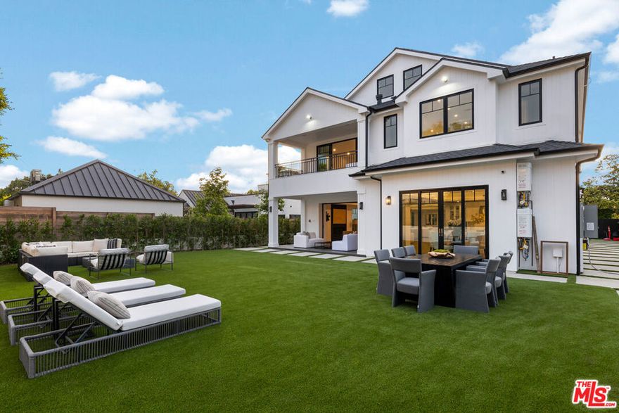 A Stunning, Newly Constructed Modern Farm House elegantly designed and located on San Vicente Bl in the prestigious north of Montana areas. This home is approximately 6,600 sqft and sits on a 10,210 sqft flat, park-like yard with five bedrooms, en suites, and a home theatre. Welcoming you as you enter is an open floor plan featuring an abundance of light. The spacious living room has a fireplace and dining area. The kitchen is a chef's dream, dressed with a WOLF stove, a SubZero refrigerator, and an oversized island. It provides the perfect space for cooking and entertaining wide-plank Oak floors that extend throughout the home, creating a warm and inviting ambiance. Sliding glass doors lead you to the park-like yard for indoor-outdoor entertaining. The primary bedroom is a true oasis, complete with a loft and private rooftop deck with views of the mountain. It also features a fireplace, a walk-in closet with built-ins, and a large terrace overlooking the backyard. This room provides a perfect retreat for relaxing and unwinding after a long day. The home also features solar panels with a backup battery, a Control 4 integrated system, Nest thermostats, and an EERO mesh wifi system, providing the latest technology and modern conveniences. Additionally, two tankless water heaters ensure that hot water is always available. Seamlessly blends contemporary design with farmhouse charm, offering luxurious and comfortable living spaces in the best spot of Santa Monica.