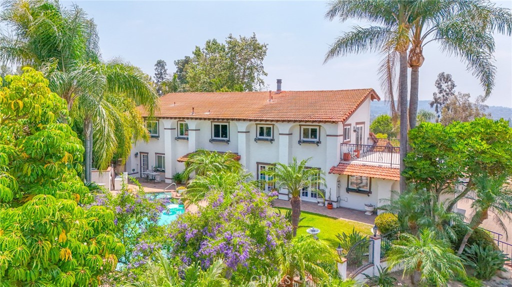 Private Spanish Equestrian Estate SITUATED IN NEARLY HALF AN ACRE * * * with STUNNING 360degree VIEWS!!!
This Extremely Rare Spanish-style residence in Anaheim Hills, CA, is located in a quiet cul-de-sac, Where it offers privacy and reduced traffic for a peaceful living environment. This estate provides 4 spacious bedrooms and 3.5 bathrooms. The exterior showcases classic Spanish architecture, featuring warm stucco finish, terra cotta roof tiles, and charming wrought-iron details. The front of the house boasts a resort style swimming pool, perfect for relaxing or entertaining guests. Additionally, the estate includes a full-size tennis court, providing space for outdoor recreation and sporting activities. Besides a carport The property has a 3 car garage and ample private parking spaces fitting well-over 10 cars.
The ESTATE combines elegant design with modern amenities, making it a perfect retreat in a desirable location. This charming estate also offers a very convenient family room/media room upstairs that can be used as a 5th bedroom or office with a large outdoor deck and an amazing view. !! Don't wait any longer- come see this beauty before it's too late!