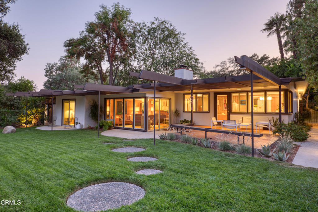Stunning Mid-Century Modern Retreat with Spectacular Mountain ViewsTucked behind a private gate and nestled on a flat half-acre wooded lot high above Eaton Canyon Golf Course, this exceptional Mid-Century Modern home offers tranquility, privacy, and breathtaking mountain views beneath a canopy of mature trees.Showcasing classic post-and-beam architecture, the home spans approximately 2,528 square feet on a 21,959 square feet lot, and features five bedrooms and three bathrooms. The stylish living room boasts rich wood paneling and expansive windows that frame the lush backyard, seamlessly blending indoor and outdoor living.The open-concept layout flows gracefully from the family room to the dining area and kitchen, with natural light pouring in through every window and captivating views of the surrounding landscape.The primary suite is a true retreat, with glass doors opening to the backyard and a luxurious en-suite bath featuring a spacious wet room with an oversized soaking tub and skylight above. A second primary bedroom includes a private atrium and its own en-suite bath--perfect for guests or multigenerational living. Three additional bedrooms provide flexibility, with two currently combined to create an oversized room. The finished garage includes a built-in workspace and abundant storage, offering both function and flexibility. Outside, the grounds are a private paradise. Mature trees and a charming front garden welcome you, while the expansive backyard features multiple sitting areas, a covered patio, and a cozy fire pit--all framed by majestic mountain views. This one-of-a-kind home offers a rare combination of architectural beauty, serene privacy, and natural splendor--an ideal sanctuary just minutes from city conveniences.