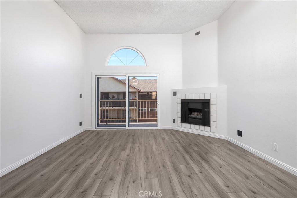 Stunning Renovated 2-Bed, 2-Bath Condo in the Heart of Long Beach. This beautifully upgraded home blends modern luxury with everyday convenience. The bright, open layout features wood flooring throughout and thoughtful details in every room. The spacious primary suite offers CAT6 cable connection, a four-gang Legrand outlet for electronics, and a quiet high speed ceiling fan with remote, while the guest bedroom includes recessed lighting, CAT6 cable, and a dedicated 20A circuit separate from room lighting and outlets. Both bathrooms have been renovated with state-of-the-art brushed nickel fixtures, extra-tall rainfall showers with magnetic handheld hoses, waterfall Delta faucets, and a new tub in the guest bath. They also feature premium Panasonic Whisper ceiling exhaust fans, including a built-in heater for added comfort. Additional upgrades include all-new plumbing valves and pipes, enhanced electrical systems, all light switches replaced, and all external outlets upgraded to Legrand Adorne tamper-resistant wall outlets. Philips Hue smart recessed lighting is installed throughout and can be controlled via Bluetooth. The kitchen boasts granite countertops, an LG refrigerator, a four-burner gas cooktop, roll-out soft-close shelving in all deep cabinets, and a Google Nest thermostat. For added privacy, the back windows and kitchen window are treated with a discreet tint. This exceptional condo also features a new roof and flashing, a Butterfly MX secure entry system, an in-unit stackable GE washer and gas dryer, a gas fireplace, and a balcony with a storage closet. Enjoy two dedicated parking spaces with two guest passes, bike storage, garage access, and robust security with cameras throughout the building. The community offers a shared jacuzzi for relaxation. Located just minutes from the Aquarium of the Pacific, Long Beach Pier, The Pike Outlets, and vibrant downtown, this turnkey residence delivers the perfect combination of style, security, and location.
