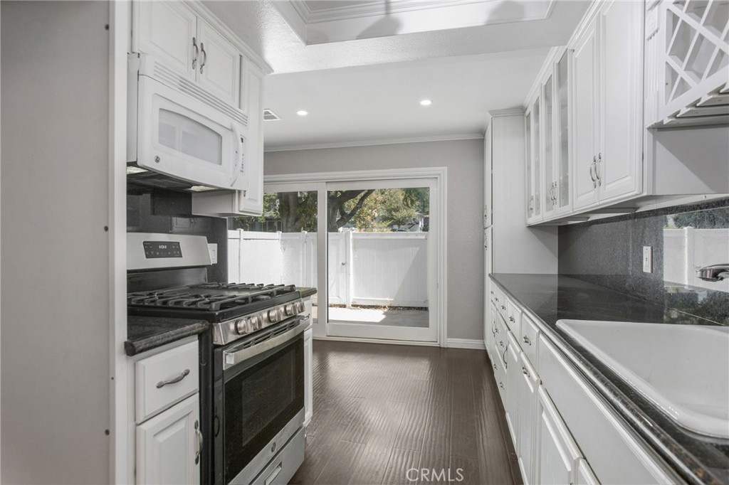 Beautiful, 3-bedroom, 2.5-bath condo in the heart of Yorba Linda! This bright and modern home features a bright white kitchen with granite countertops, stainless steel stove, and extra cabinets perfect for storage. Fresh interior paint, sleek can lighting, and stylish wood and tile flooring throughout the main living areas and bedrooms. Each bedroom has custom built-in closets, can lights, new LVT flooring and new paint. Enjoy the convenience of a two-car attached garage, and relax or entertain in the private enclosed patio with white vinyl fence. Located in a well-maintained community of Fairmont Hill known for its peaceful setting, excellent community amenities, and access to top-rated public schools. The location offers easy freeway access and is just a short drive from Carbon Canyon Regional Park, and the Susanna Bixby Bryant Museum & Botanical Garden. The community features include a swimming pool and spa, clubhouse, outdoor cooking and picnic areas, barbecue stations, a playground, and added security for peace of mind, close to top-rated schools, shopping, and dining—this home offers both comfort and convenience.