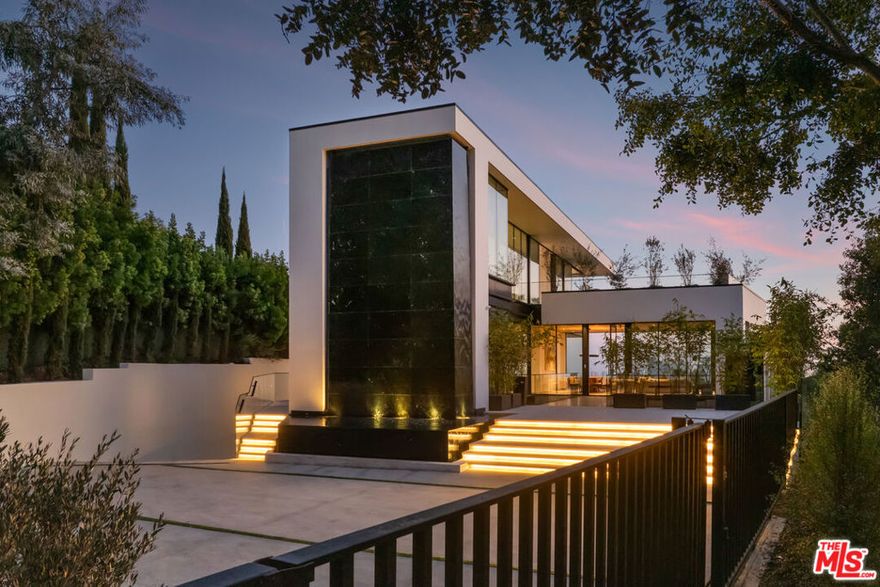 A stunning brand-new Beverly Hills architectural triumph comprised of steel, glass, & stone in an unparalleled location overlooking spectacular city to ocean views. A collaboration of world class visionaries modernist Paul McClean and AD100 interior designer Waldo Fernandez. Situated on a private promontory behind gates, follow the steel and glass catwalk into a grand entryway, living/dining/great room, gourmet kitchen with separate chef's kitchen, family/media room, office, separate professional theater & incredible onyx bar and game room, resort-like spa, gym & wellness center and much more. Spectacular primary suite with head-on views and light imported stone bath and large walk-in closet. Walls of glass and great walls for art intersect incredible outdoor areas, infinity pool, and courtyard garden with a cascading waterfall. An incredible value that can't be replicated. Shown to pre-qualified clients.