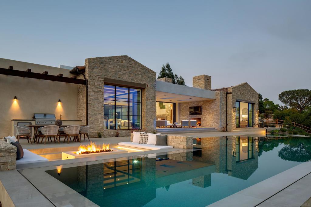 Discover refined living at the BRAND-New 2024 custom construction designed to perfection featuring Detached Guest Home on 2.04 VIEW acres on the widest street in premier Rancho Santa Fe Covenant. This Ultra-Luxe Estate seamlessly integrates indoor/outdoor living with sliding glass walls, grand light-filled living spaces, and Breathtaking Panoramic Vistas, elevating your lifestyle in this turnkey estate. Showcasing an expansive skylit veranda that beckons alfresco dining by the outdoor fireplace overlooks the zero-edge pool and spa, featuring a sunken fire-pit area with LED lighting for evening ambiance. Lutron lighting, Sonos surround, Nest, & Pentair app technology seamlessly integrates smart living. Indulging gourmet kitchen outfitted with top-of-the-line Wolf and SubZero appliances, complemented by Calacatta gold marble countertops and custom oak cabinetry. Featuring 5 bedrooms on the main level, a light-filled office, Powder bath with Borghini marble, fully-equipped wellness gym, temperature-controlled walk-in wine cellar, oversized game lounge with wet bar, 4-car garage, & lush landscaping. Primary suite is a luxurious retreat with Views above it all, Venetian plaster fireplace & custom built-ins creating a tranquil ambiance, while a Spa-like bath is the perfect sanctuary to unwind w/ large soak tub, private fountain courtyard, His/Her closets. Access to 60 miles of Covenant walking & running trails at entrance of street & ideal access to the Village, Roger Rowe Schools & Covenant Golf. Enjoy the ultimate in luxury living & a lifestyle unmatched in refinement.