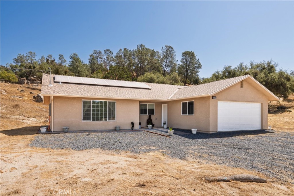 Welcome to comfortable country living in this charming single-story home in Coarsegold. Situated on a usable 1.55-acre lot, this 3-bedroom, 2-bathroom home offers 1,350 square feet of bright, open living space with expansive windows that fill the home with natural light and showcase peaceful views of the surrounding landscape.
Inside, you’ll find new laminate flooring and a spacious, open-concept layout. The kitchen features modern appliances and generous cabinet space, ideal for daily living and entertaining. The primary suite includes an ensuite bath and added closet space, while the additional bedrooms offer flexibility for guests, an office, or hobbies. Both bathrooms are tastefully updated with elegant tilework and contemporary finishes.
The home is equipped with energy-efficient features, including solar panels that help lower monthly utility costs and contribute to long-term savings. A detached garage offers parking, storage, or workspace potential. Schedule your showing today!