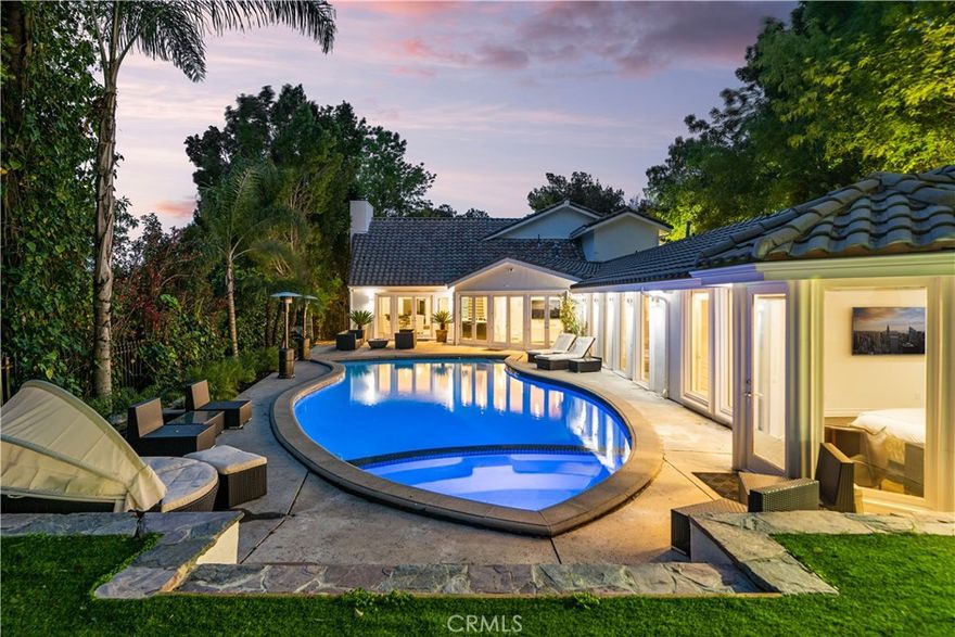 Welcome to 16221 Elisa Pl, an extraordinary furnished lease opportunity with luxury furniture that perfectly blends elegance, exclusivity, and comfort in one of Encino’s most coveted neighborhoods. Tucked away on a secluded half-acre, this 5-bedroom, 6-bathroom estate spans 4,483 sq. ft. of refined living. From the moment you arrive, a private, gated entrance opens to your own long private drive—shielding the property from view and leading to a custom motor court with a spacious driveway and ample guest parking. This dramatic sense of arrival ensures unmatched privacy and true estate living.

Surrounded by lush greenery and breathtaking views, this tranquil retreat feels worlds away, yet remains just minutes from the vibrant heart of Encino. Inside, soaring ceilings, walls of windows, recessed lighting, and crown molding fill the home with light and sophistication. The furnished interiors, thoughtfully designed with luxury furniture, complement the chef’s gourmet kitchen—featuring premium appliances and two generous seating areas—ideal for everything from casual mornings to lavish dinner parties. The primary suite occupies the entire upper level, creating a private sanctuary with a versatile lounge/office space, oversized walk-in closet, spa-inspired bathroom, and an expansive private terrace with serene views. Designed for both relaxation and entertaining, the resort-style backyard showcases a sparkling pool, rejuvenating hot tub, and lush landscaping—all framed by absolute seclusion. Additional features include solar panel installation that significantly reduces the DWP power bill, a Ring security system, designer outdoor lighting, and a gated motor court. Located south of Ventura Boulevard, this prestigious address offers effortless access to upscale shopping, fine dining, top-rated schools, and places of worship—while preserving the rare privacy of a true hidden estate.