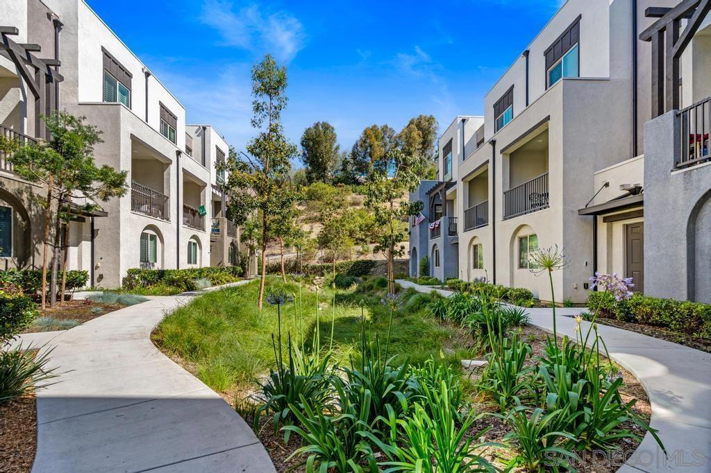 Stunning End Unit Townhome filled with designer upgrades. Deluxe kitchen w/Italian tile backsplash and custom island. Mohawk flooring throughout with one carpeted guest bedroom. Primary bedroom with natural light due to the corner location. Primary closet upgraded by Conquering Clutter. Larger Garage with Epoxy flooring & storage cabinets. Whole house fan/HVAC/security system. Complex amenities include: electrical charging stations, pool, tot-lot, event clubhouse, gated entrance. Neighborhood has (within a five mile radius): Ayres hotel for visiting guests (walking distance), Carlsbad State Beach, Premium outlet shopping & numerous dining/shopping/grocery options at Bressi Ranch. Located in the highly rated school district of San Marcos. Smart Home Technology. Custom shades.