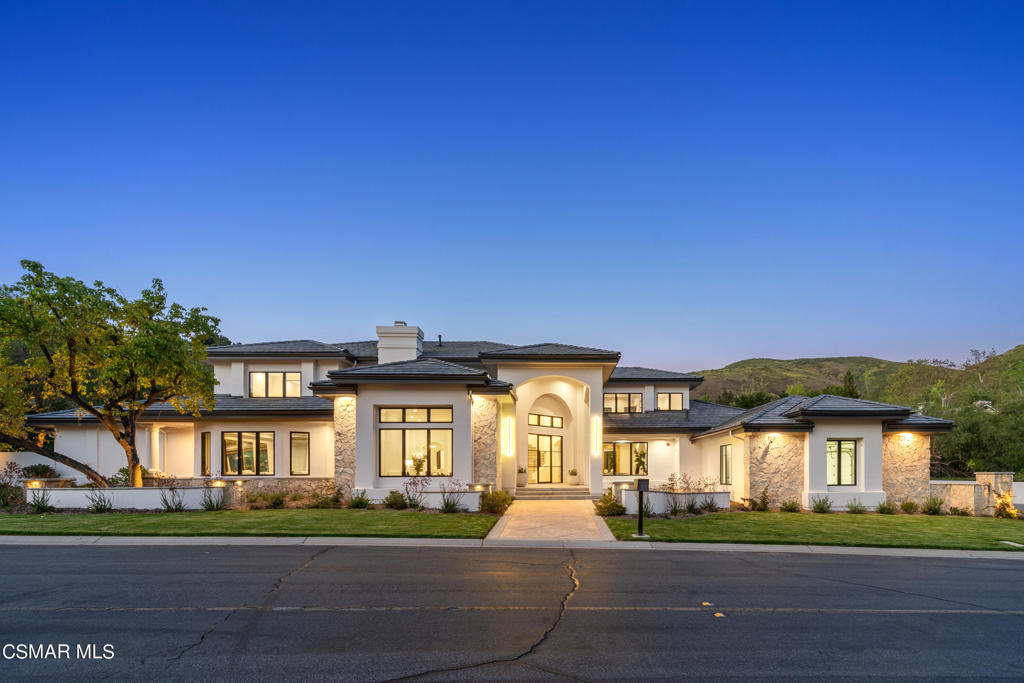 Nestled within the serene and prestigious enclave of North Ranch Country Club Estates, this newly renovated contemporary estate epitomizes luxury living on a sprawling 1.3-acre lot. Boasting a generous 6,670 square feet of meticulously crafted living space, this chic residence redefines indoor-outdoor lifestyle with its exceptional amenities and stylish design.Upon entering, the home welcomes you with a sense of sophistication and comfort. The bright and airy gourmet kitchen flows seamlessly into the family room, creating an inviting space for gatherings and entertainment. Featuring Rift Sawn Oak Custom Cabinetry, complete Thermador Appliances, including refrigerator/freezer columns, stove, and ovens, as well as elegant Brizo faucets and striking Moooi Pendant lights by Dutch Nederland Designers, the kitchen is truly a centerpiece of the home. Additionally, a dedicated coffee/tea station and Taj Mahal quartzite at the island enhance its functionality and beauty. The quartz backsplash adds a contemporary touch to the space.A stunning media room adds versatility, ideal for relaxed evenings or lively screenings. This space includes a dedicated wall for projection or a large TV, and alluring custom woodwork.The primary bedroom suite, conveniently located on the main level is a retreat unto itself, featuring a cozy fireplace, dual walk-in closets, and a spa-inspired bathroom complete with a soaking tub. The bathrooms throughout showcase large format tile work and custom Rift Sawn Oak vanities, emphasizing luxury and sophistication.Each of the five bedrooms is thoughtfully designed for privacy and comfort, providing ample space for family and guests. The dining room boasts recessed lighting in beam detail, creating an elegant atmosphere for meals and gatherings.Throughout the home, recent renovations ensure modern comfort and functionality. All New Marvin Windows and Doors allow natural light to illuminate the living spaces while enhancing energy efficiency. A New Roof provides peace of mind and enhances the property's aesthetic appeal. Updated Plumbing and Electrical systems offer reliability and safety. Engineered Oak Floors bring warmth and durability to every room. The installation of New Fire Suppression Sprinkler Heads enhances safety measures, while a New HVAC system ensures year-round comfort.Outside, the estate's allure continues with mature, lush landscaping enveloping the grounds, offering a sense of tranquility and seclusion. A sparkling pool and spa beckon for leisurely afternoons spent basking in the California sun.The expansive four-car garage offers abundant storage and convenience for car enthusiasts. It also provides direct access to the back kitchen, which boasts additional features including a beverage center, small appliance counter, cabinets for large packages, a designated mail station, and cubbies at the garage entry for organized storage.Located within a guard-gated community, this property ensures unparalleled privacy and security. Yet, it remains conveniently close to the vibrant amenities of Westlake Village, including upscale dining, boutique shopping, and entertainment options.This newly reimagined estate represents the pinnacle of contemporary elegance, where stylish comfort harmonizes with effortless leisure. Welcome to a fresh lifestyle--a secluded haven that is as luxurious as it is inviting, offering a timeless escape from the bustle of everyday life.