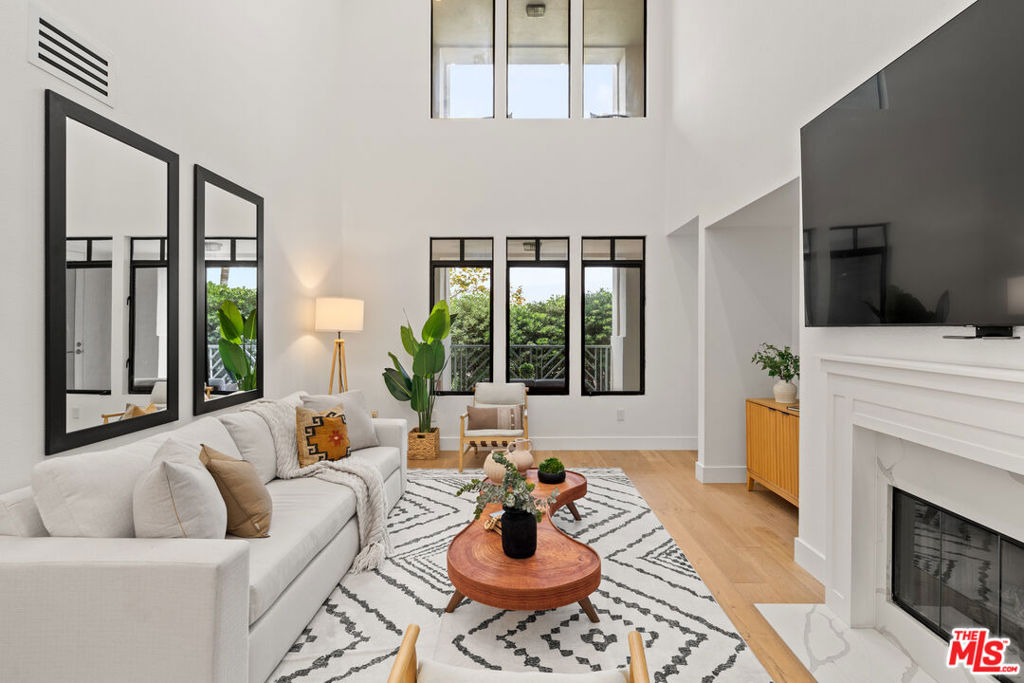 Enjoy luxury living in the heart of Playa Vista! This beautifully renovated, 3 Bed + Den, 2.5 Bath, 2200 sqft condo is centrally located in Playa Vista's coveted Metro community. Upon entering, this unit is flooded with natural lighting featuring soaring 10-foot ceilings with oversized windows, filling the home with a bright & airy living space perfect for entertaining & family gatherings. The main downstairs level boasts an open-concept living room complemented by the voluminous ceiling height & a cozy fireplace. The gourmet kitchen anchors the space, newly renovated with white & gray quartz countertops, engineered white oak hardwood flooring, custom white shaker cabinets, brand new Thermador stainless appliances, wine fridge, & generous pantry storage, flowing seamlessly into the formal dining room. Situated off the kitchen is a spacious den, perfect for a home office or play area, leading to an inviting patio for seamless indoor-outdoor living. The downstairs level also showcases one spacious bedroom and powder bath. Upstairs, the expansive primary suite includes a soaking tub, walk-in rain shower, dual sinks, spacious walk-in closet, & a private, expansive patio. On the opposite wing, is an additional bedroom & full bath, positioned for added privacy. Additional highlights include: in-unit Washer & Dryer, central HVAC, & two side-by-side parking spots in the gated community garage, ensuring secure and hassle-free parking. HOA dues include -- Wi-Fi with 1Gbps fiber internet, Cable TV, Water, and access to Playa Vista's state of the art Resort & Center Pointe fitness centers, pools, & spas. Experience the convenience of living in Playa Vista, with easy access to all the amenities and attractions the heart of Silicon Beach has to offer -- including the community's pickleball and tennis courts, basketball courts, dog parks, and more! Conveniently located near Runway's shops and restaurants, Whole Foods, the 90 freeway, LAX, and Marina del Rey.