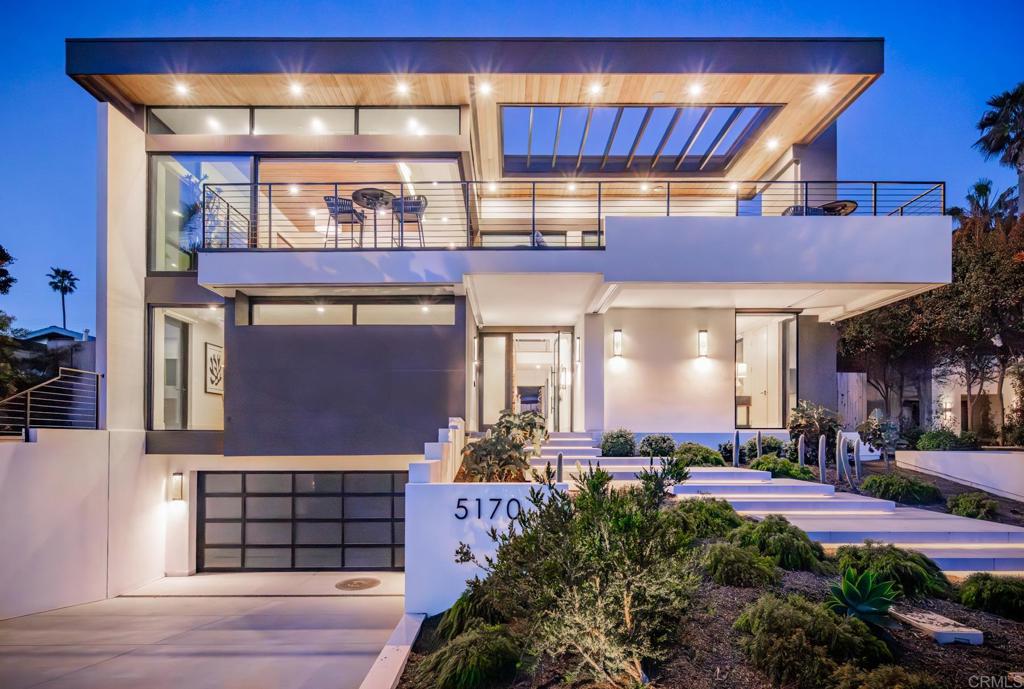 The crown jewel of Terramar, a striking, modern coastal retreat just steps from the sand. From the moment you step inside, the home’s elevated architecture and contemporary palette of blues, creams, and grays set the tone for refined beachside living. Every detail speaks of craftsmanship and cutting-edge luxury. This newly constructed 4 bed, 4.5 bath, 3,925 SF masterpiece was imagined as the tallest home on the street, thoughtfully designed across three levels plus a rooftop deck to fully capture panoramic ocean views. The community of Terramar comes with its own private beach access, The Landing, the biggest bonus for the new owner of this magnificent estate, offering an exclusive way to enjoy the coastal lifestyle just steps away. A sleek Savaria Eclipse Residential Elevator connects every floor, offering effortless access from the private garage to the top level, a true blend of convenience and sophistication. The entry level boasts three impeccably designed bedrooms, three full baths, and a family room that opens seamlessly to the backyard, an entertainer’s dream complete with a custom outdoor kitchen with Lynx pizza oven and 42” grill, bistro island, designer fire pit table, Kannoa Motion Cabana with retractable awning, hot tub, and outdoor shower, all framed by water-conserving landscaping and artistic lighting. The main living space and the heart of the home is located on the top floor to maximize ocean views and includes a showstopping kitchen outfitted with Wolf and Subzero appliances, dual Asko dishwashers, a full-size wine fridge, and striking walnut and white cabinetry. The kitchen flows seamlessly into the dining nook and ocean-facing great room, where doors vanish to reveal a vast deck, your front-row seat to nightly sunsets. Located in its own private wing, the luxurious ocean-view primary suite offers an elevated retreat with a spa-inspired bath, a stylish powder room, and direct access to the rear deck and the outdoor entertaining area below. The lower level includes a finished 4-car garage with EV charging, a private wine cellar with 160+ bottle capacity, and access to smart home systems. Sustainable and smart, the home features owned Enphase solar with monitoring system, water-conserving landscaping, security cameras, Kumo Touch thermostats, myQ garage access, and high-efficiency HVAC systems. A highlighted feature is the complete Control4 system with lighting, Lutron Palladiom Motorized Roller Shades, distributed audio, security, and surround sound integrated into one app. This is more than a home. It’s a statement of lifestyle, where every detail was curated for coastal elegance, smart functionality, and unforgettable entertaining.