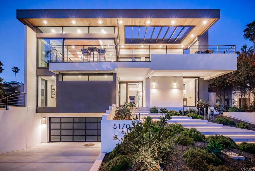 The crown jewel of Terramar, a striking, modern coastal retreat just steps from the sand. From the moment you step inside, the home’s elevated architecture and contemporary palette of blues, creams, and grays set the tone for refined beachside living. Every detail speaks of craftsmanship and cutting-edge luxury. This newly constructed 4 bed, 4.5 bath, 3,925 SF masterpiece was imagined as the tallest home on the street, thoughtfully designed across three levels plus a rooftop deck to fully capture panoramic ocean views.  The community of Terramar comes with its own private beach access, The Landing, the biggest bonus for the new owner of this magnificent estate, offering an exclusive way to enjoy the coastal lifestyle just steps away.  A sleek Savaria Eclipse Residential Elevator connects every floor, offering effortless access from the private garage to the top level, a true blend of convenience and sophistication. The entry level boasts three impeccably designed bedrooms, three full baths, and a family room that opens seamlessly to the backyard, an entertainer’s dream complete with a custom outdoor kitchen with Lynx pizza oven and 42” grill, bistro island, designer fire pit table, Kannoa Motion Cabana with retractable awning, hot tub, and outdoor shower, all framed by water-conserving landscaping and artistic lighting.  The main living space and the heart of the home is located on the top floor to maximize ocean views and includes a showstopping kitchen outfitted with Wolf and Subzero appliances, dual Asko dishwashers, a full-size wine fridge, and striking walnut and white cabinetry. The kitchen flows seamlessly into the dining nook and ocean-facing great room, where doors vanish to reveal a vast deck, your front-row seat to nightly sunsets. Located in its own private wing, the luxurious ocean-view primary suite offers an elevated retreat with a spa-inspired bath, a stylish powder room, and direct access to the rear deck and the outdoor entertaining area below.  The lower level includes a finished 4-car garage with EV charging, a private wine cellar with 160+ bottle capacity, and access to smart home systems.  Sustainable and smart, the home features owned Enphase solar with monitoring system, water-conserving landscaping, security cameras, Kumo Touch thermostats, myQ garage access, and high-efficiency HVAC systems. A highlighted feature is the complete Control4 system with lighting, Lutron Palladiom Motorized Roller Shades, distributed audio, security, and surround sound integrated into one app.  This is more than a home. It’s a statement of lifestyle, where every detail was curated for coastal elegance, smart functionality, and unforgettable entertaining.