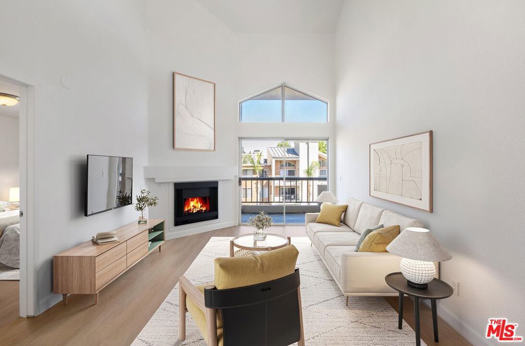 Introducing a highly desirable top-floor end unit in The Met in Woodland Hills. Featuring the coveted "2F" floor plan, this 2BD/2BA home includes an open floor plan with high ceilings and a versatile loft space perfect as a home office, guest room or an additional living area. The living room offers a cozy fireplace and leads you out to a balcony, perfect for dining al-fresco. The kitchen has stainless steel appliances and plenty of cook and prep space. Both bedrooms are en-suite and each is situated on a separate wing of the unit which is ideal for privacy. The primary bedroom has dual vanities and a spacious walk-in closet. The home also has in-unit laundry and two assigned parking spaces in the community garage. The Met provides the comfort and peace of mind of a 24/7 guard-gated community with continuous access management and patrol services. The HOA fee covers water, sewer, trash and earthquake insurance as well as access to resort-like amenities including four pools, spas, six tennis courts, a state-of-the-art fitness center, indoor basketball and racquetball courts, sauna, playgrounds, clubhouse, and 26 acres of landscaped grounds all located minutes from all the shopping, dining, entertainment, and transit in the heart of Warner Center. Welcome!