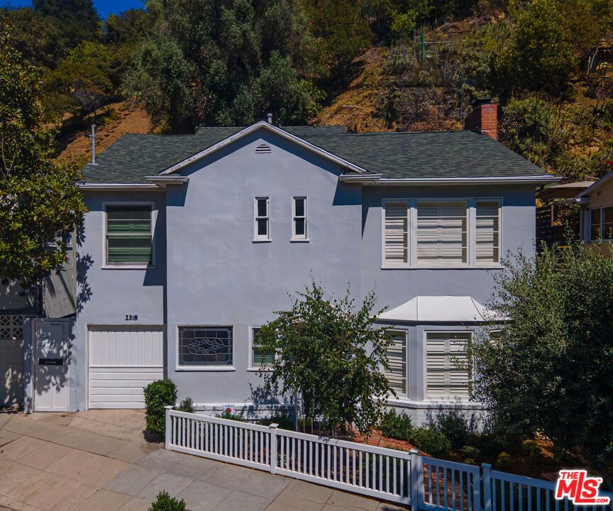 This well-kept Hollywood cottage is dripping in charm. Three large rooms upstair and an elegant full bath lead off to a newly refurbished deck for taking in a nature bath or enjoying the summer evenings. The public rooms on the first level have oak flooring and the jewelry of a magnesite stair case with a rod iron handrail. The well equipped kitchen has a polished Wedgewood stove and a French door out to a lovely patio to enjoy a morning coffee. The living room has a bay window for afternoon light and a fireplace for cozy evenings at home. Griffith Park hiking trails are just at then end of the street. Gelson's and Lazy Acres are on Frankin as well as many nice restaurants and shops. Take a tour and imagine your life in this Bronson Canyon beauty.
