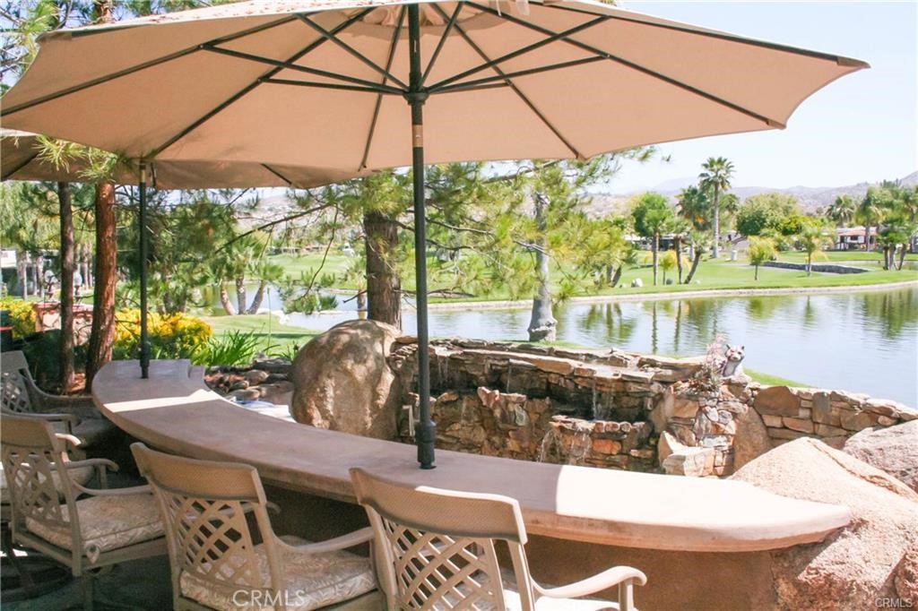 This unique lot offers features that can't be found together anywhere else in the park. Over $200k worth of custom stonework creates your own private desert paradise. Resort-style living awaits just down the steps from your RV with a large sunken living room complete with built-in fireplace & entertainment center with surround sound, all designed to stand up to Southern California's roughest tropical weather. On the other side of the living room, you'll find yet another fireplace, spacious dining area, and huge custom bar, backed by an infinity-edge waterfall which meets seamlessly with the lake view- just steps away across a lush lawn. Lot also features washer & electric dryer hook-ups (no longer allowed on new builds), full landscaping with mature pine trees. The community itself has a plethora of desirable features including: Private 24-hour security with gate & guard station, golfing, hiking, biking, swimming pools & spas, community events, & the 15th Hole Restaurant. Central to Palm Springs, San Diego, & Temecula's Wine Country. This lifestyle community is one of the only resorts in So Cal to offer individual ownership and customization of their lots! Come check this one out! Financing Available...