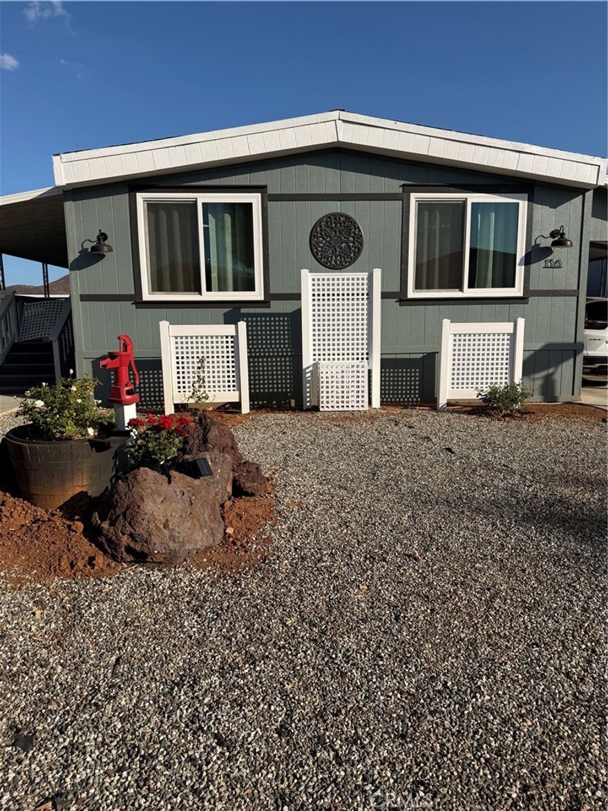 EXPERIENCE the cozy living in this modern farmhouse style remodeled,  1975 Fleetwood double wide, 2 bedroom, 2 bath, home located in the sought-after 55+ gated community within the Sun City Mobile Estates. The home offers a welcoming comfortable living.  The heart of the home is bright and light with the open concept kitchen, dining, living area.  Throughout the home is luxury vinyl flooring. The kitchen is equipped all new stainless steel appliances, along with soft-closing new shaker cabinets, white washed Butcher block counters which makes a very functional kitchen. The Primary bedroom offers his and her closets, with built in drawers for plenty of storage. The Primary bathroom is adjacent to the bedroom with a walk-in shower. The Primary bathroom has been update with a new vanity top & shaker cabinet.  The home comes with a washer & dryer within its own laundry room. The home's curb appeal has rock landscaping with lattice and roses. The large lot in the backyard has a gazebo with plenty of room for entertaining and out door living. Some of the updates include a new roof, double pane windows, front porch carpeting.   This home is located a short distance away from shopping and restaurants. The park offers many amenities, clubhouse, pool/spa, and along with social activities.  Don't miss out on this lovely home!