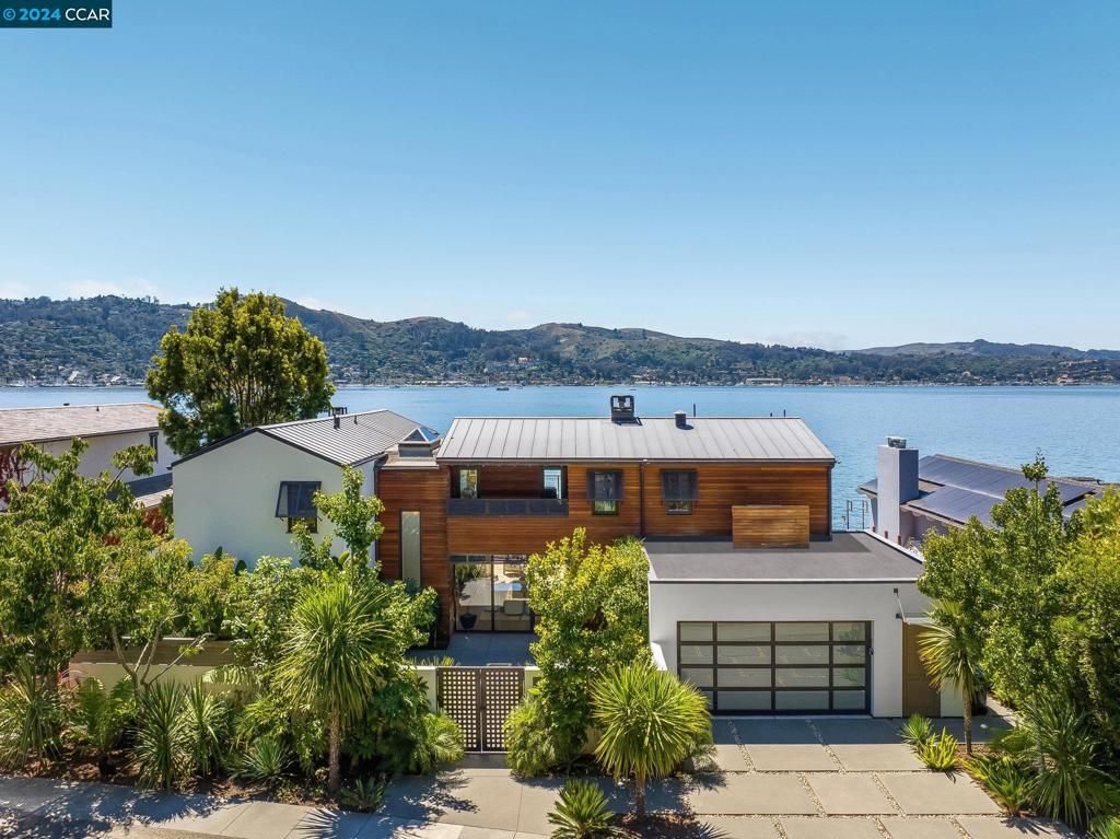 Welcome to where modern luxury meets WATERFRONT living in Belvedere. This stunning newer home is a true gem on one of the most sought after streets in the area. With 4 bedrooms -4.5 bathrooms plus an office, this home offers spectacular VIEWS with the perfect blend of comfort and style. The natural light filled open floorplan seamlessly connects the living, dining and kitchen areas The gourmet kitchen features stunning island, high end appliances as well as a unique galley butler's pantry featuring additional refrigeration drawers, built in coffee maker, wine frig, sink, storage and microwave. Step outside to the expansive deck and take in the breathtaking views of the San Francisco Bay, Sausalito, and the Bay Bridge.The pocket Nano style doors throughout the home open to these stunning vistas creating a true sense of indoor outdoor living. Primary suite has its own deck, fabulous closet, and gorgeous bath. Your private boat dock, expansive deck, hot tub and view sets the tone for a "vacation at home."