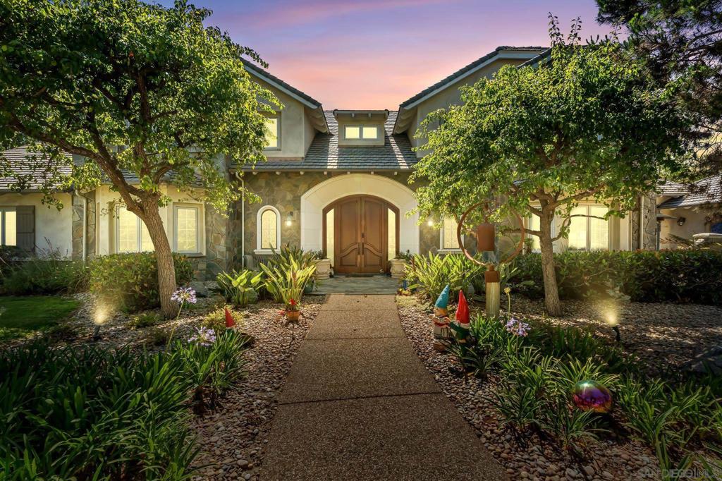 VALUE RANGE - $5,400,000 - $6,000,000 Welcome to this extraordinary custom estate offering ultimate privacy and luxury behind its own private gate complete with resort size pool and backyard, waterslide, entertainment spaces and ponds completing the serene aesthetic. The main residence spans approximately 7,938 sqft and features four spacious ensuite bedrooms and optional bedroom spaces, 4.5 bathrooms, formal and informal living areas, a gourmet kitchen with high-end appliances, and a large family room designed for entertaining and everyday comfort. Upgraded lighting throughout completes this expansive living and floor plan. The primary suite is a true sanctuary, featuring a cozy fireplace, dual walk-in closets, a private sitting room with its own balcony, and an attached private gym—creating the perfect space for relaxation and wellness. A standout feature of the property is the detached large guest house, offering a full bedroom and bathroom, kitchen, and living room—ideal for long-term guests or multi-generational living. Set on beautifully landscaped grounds with expansive patios, this residence offers peace, space, and elegance in one of Rancho Santa Fe’s most desirable locations. A circular driveway and oversized garage complete this exceptional offering. Conveniently located close to shops, grocery stores, farmers market, beaches & easy access to the freeway. Other: *Top Tier School District San Dieguito Unified. *Solar Panels Owned *Preventative Leak system