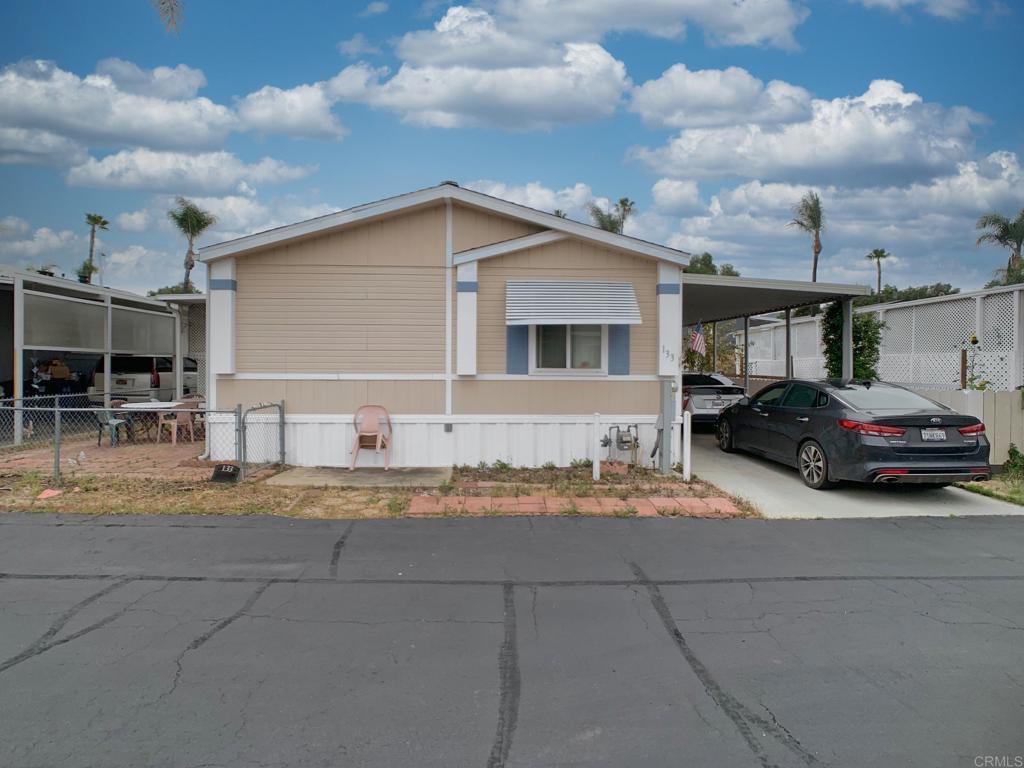Welcome to one of the largest and most spacious manufactured homes on the market, located in a quiet and peaceful all-ages park. This beautifully updated manufactured home features 3 generous bedrooms plus an optional living space or entertainment room, giving you flexibility to fit your lifestyle. Step into a open-concept living area and an enclosed patio that gives more space—ideal for lounging, hobbies, or extra living space. The remodeled kitchen with wraparound counters and modern appliances flows into a dedicated dining area. Outside, unwind on your shaded patio, and take advantage of a private backyard, storage shed, low-maintenance yard, and covered carport. Enjoy two bathrooms, including a walk-in shower, and relax in the comfort of central heat and A/C, new carpet, and a walk-in closet. Nestled in a secluded spot near guest parking and freeway access, and excellent access to the community pool and clubhouse, this home offers the space, privacy, and convenience you’ve been looking for.