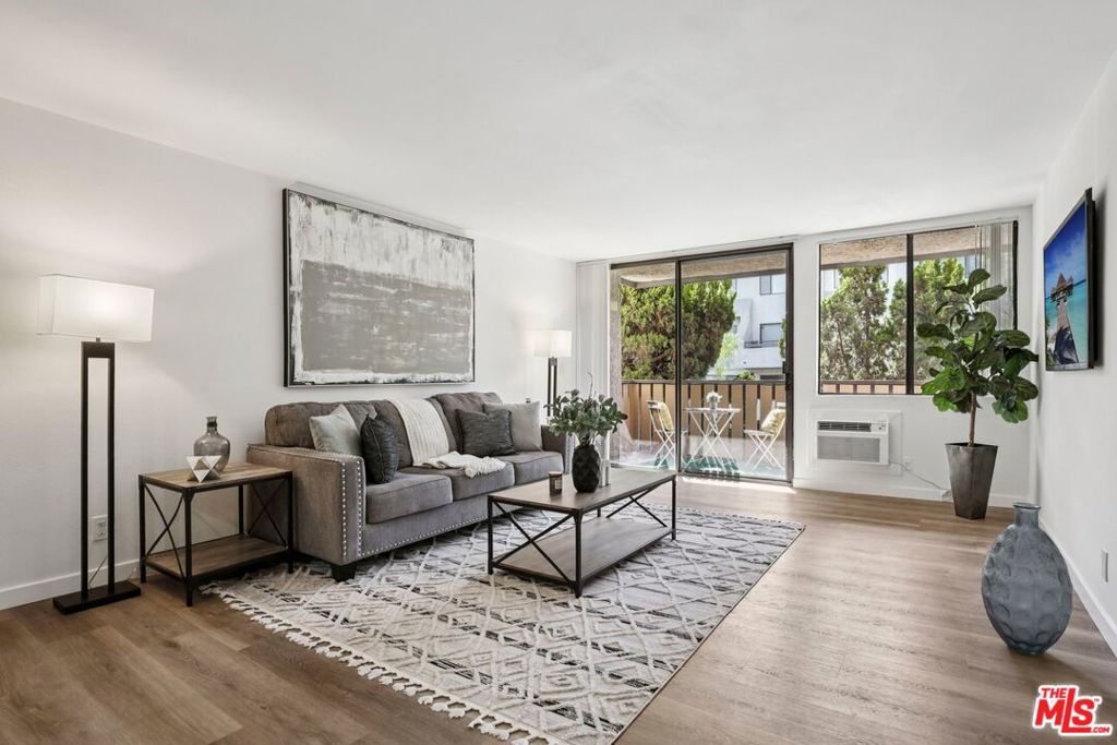 Welcome to this impressively updated, light-filled 2-bedroom, 2-bath condo in the heart of Bixby Knolls! The open layout showcases smooth ceilings, recessed lighting, Quartz countertops, a breakfast bar, and gleaming new stainless steel appliances, including a range/oven, microwave, and refrigerator, while flowing effortlessly into two private balconies with serene treetop views. The primary suite boasts a remodeled ensuite bath, a generous walk-in closet, and its own balcony retreat. The secondary bedroom features its own walk-in closet and is conveniently located near a beautifully renovated hall bath. Comfort is enhanced with a wall-mounted A/C unit, radiant ceiling heating, and in-unit laundry hookups, featuring a stackable washer/dryer tucked into a convenient hall closet. Two secured, covered parking spaces, along with low HOA dues covering water, trash, and exterior maintenance, make life easy. Ideally located just blocks from fitness at Crunch Gym, food at Trader Joe's, and fun at SteelCraft, Uptown Village Market, and charming boutiques, breweries, and eateries along Atlantic Avenue, you're also close to Rancho Los Cerritos, Bixby Knolls Park, and top-rated schools. For longer ventures, California State University, Long Beach is nearby, and Long Beach City College is within a 10-minute drive or less. With its tree-lined streets and welcoming vibe, Bixby Knolls is a wonderful place to stroll, roll, or unwind with pets, neighbors, and family, making this stylish, spacious condo the perfect place to call home.