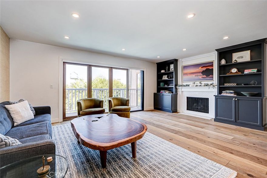 Set in a quiet, desirable area of East Manhattan Beach, this beautifully remodeled 3-bedroom, 3-bath home offers modern style, thoughtful design, and relaxed coastal living. Upstairs, an open-concept layout blends the kitchen, dining, and living areas, creating a bright and inviting space perfect for everyday living and entertaining. The kitchen features sleek cabinetry, a large center island with breakfast bar seating, quartz counters, geometric backsplash, and double ovens — all overlooking the dining area with stylish lighting and warm wood flooring throughout. The living room offers built-in cabinetry, fireplace, and a wall of sliding glass doors that open to a balcony with views of the lush backyard — a perfect spot to enjoy morning coffee or evening sunsets. The primary suite, located on the main level, feels like a retreat with its spa-inspired ensuite bath showcasing dual vanities, floating cabinetry, a soaking tub, frameless glass shower, and designer tile finishes. Downstairs you’ll find two additional bedrooms, a spacious bonus area ideal as a family room, home office, or kids’ hangout, plus a dedicated laundry area. One bedroom enjoys a private ensuite bath, while the other has access to a beautifully updated hall bath featuring designer wallpaper and modern tile work. Step outside to a serene backyard oasis with a sparkling pool, removable safety fence, sun deck, and lush tropical landscaping — perfect for outdoor dining, lounging, and entertaining year-round. Additional highlights include wide-plank hardwood floors, recessed lighting, custom window treatments, newer windows and doors, and an enclosed 2-car garage with a Tesla charger. Located on a quiet street just minutes from award-winning Manhattan Beach schools, parks, dining, and the beach, this home truly combines comfort, convenience, and California coastal living at its best!
