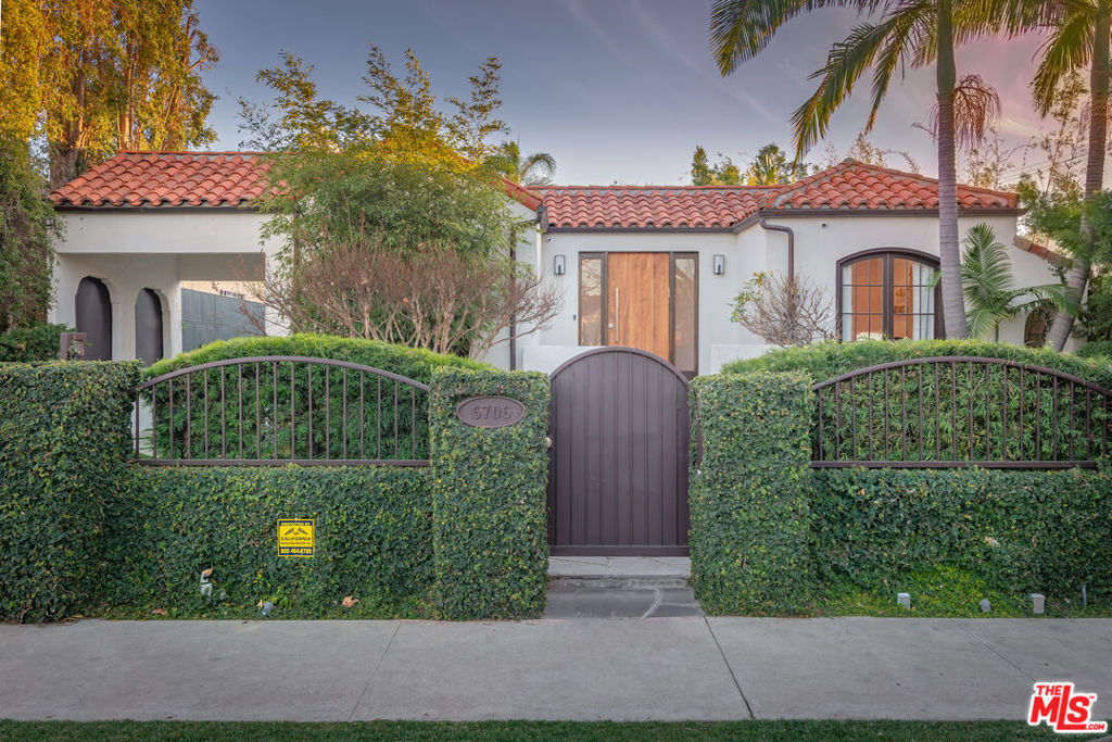 Set behind gates on one of Beverly Grove's most sought-after streets, this beautifully remodeled Modern Spanish home offers privacy, security, and high-end living just moments from world-class shopping, dining, and entertainment. Designed for effortless indoor-outdoor living and entertaining, the sunlit interiors feature wide-plank wood floors, beamed ceilings, and French doors throughout. The expansive great room with fireplace opens to a private backyard oasis with lush hedges, a patio, lawn, and a full outdoor BBQ kitchen. The chef's kitchen is outfitted with Wolf and Sub-Zero appliances and flows seamlessly into the main living spaces. The generous primary suite includes dual walk-in closets and a luxurious spa bath with steam shower and direct access to the yard. A spacious third bedroom can serve as a second primary suite. A large bonus/recreation room perfect for a gym, office, or studio is included in the square footage. Additional features include a Control4 smart home system and advanced security. Available unfurnished for a minimum one-year lease beginning October 1, 2025 (early move-in may be possible). Lease term is a minimum of 12 months. Owner covers landscaping, tenant is responsible for all other utilities, including LADWP and gas.