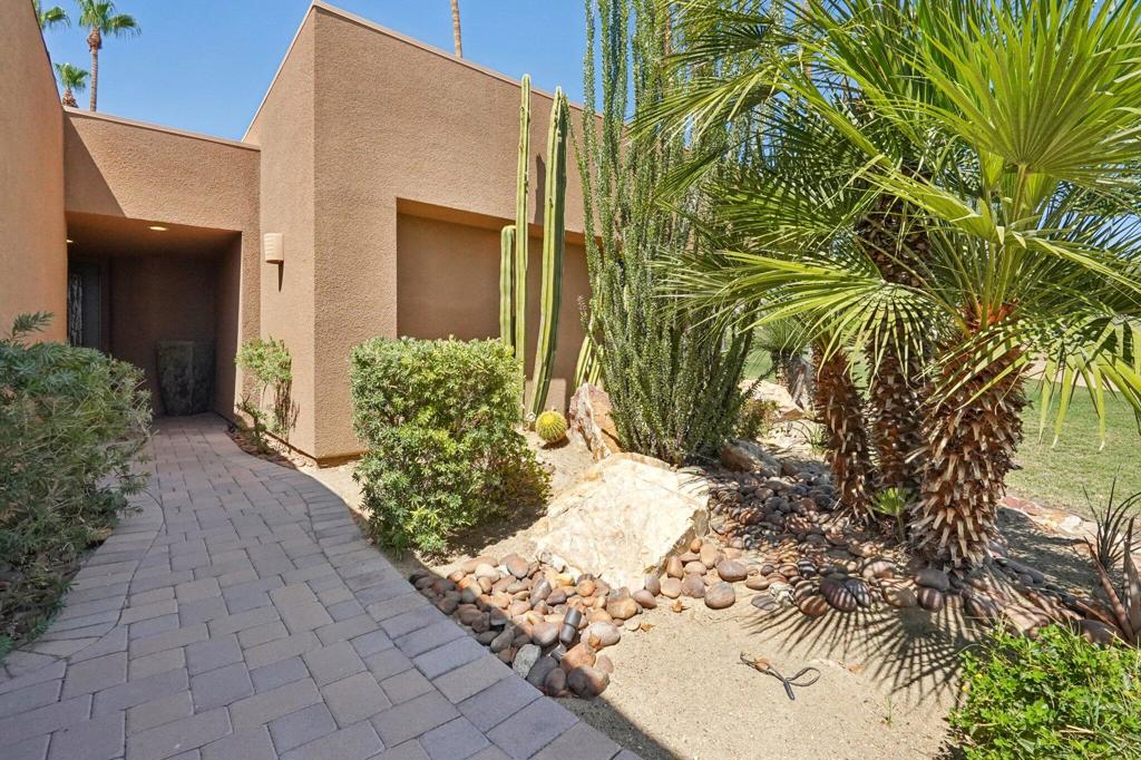 As you approach the property, you can appreciate the custom landscaping that has been thoughtfully designed. It sets the tone for the elegant home that awaits inside. Walking up the pathway, you can enjoy the views of the mountains to the south and west. Upon entering, you are greeted by a spacious foyer that leads into the kitchen, which boasts fairly new, sleek charcoal top-of-the-line Kitchen Aid appliances. The deep charcoal appliances against the white cabinetry create an elegant space where you can prepare delicious meals.The kitchen opens into a well-appointed family room; a feature not commonly found in these homes. The family room offers plenty of space to relax and unwind. It also showcases beautiful double French doors that lead to the expansive patio. The patio is equipped with a plumbed gas barbeque and a table for six, perfect for outdoor dining.The patio wraps around to the back, where you can watch the family enjoy a game of croquet. Inside the home, there are two primary bedrooms plus a 3rd bedroom converted to a Flex room easly to be converted back to the third bedroom. ,The living room, and dining room. The primary bathroom has been expanded and has custom cabinetry. The home spans 1980 square feet, offering ample space for everyone. It has been professionally decorated to feel warm, inviting, and full of elegance.This is a must-see property--immaculately furnished, well-maintained, and located in an excellent area, close to all amenities.
