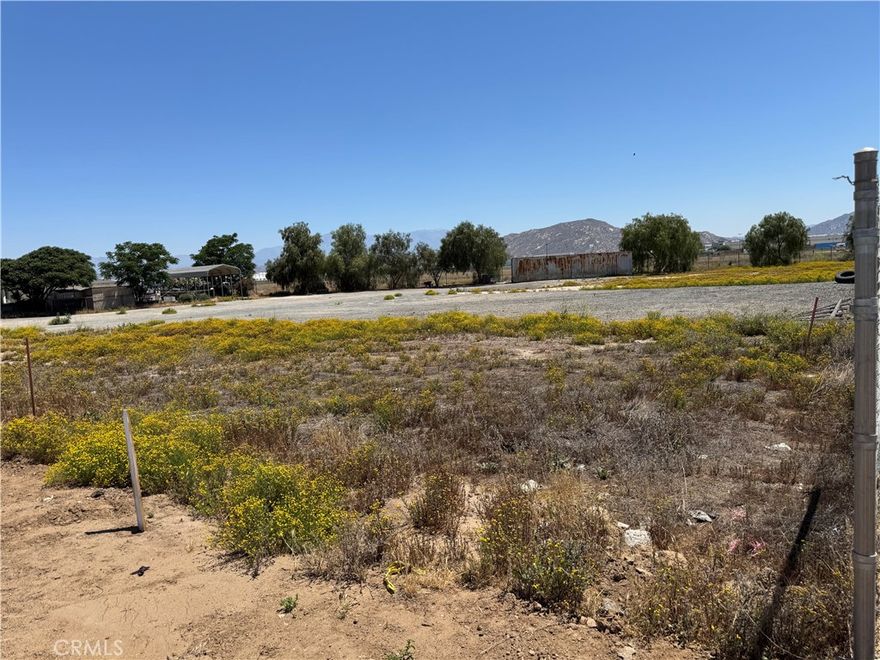 Streets have recently been paved. The value for this property is on the land, which consists of 4 parcels (314-153-050, 314-153-052, 314-153-054, and 314-153-056). These parcels are zoned commercial for general industrial use. On parcel number 314-153-052 there's a 3 bedroom/2bath 1,712 sqft home that's fully electric. There's also a gas meter on this parcel.