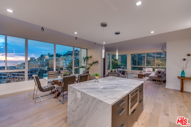 ophisticated completely remodeled contemporary 2 bed/1.75 bath with stunning open ocean, mountain and sunset views. Filled with natural light & top quality interior with high-end finishes throughout. Chic open floor plan with views from every room. Living room w/ large windows, fireplace w/ marble finishes. Dining room overlooking ocean views and stunning spacious chef's kitchen w/ center island and breakfast bar, quartz countertops, high-end stainless steel appliances & new cabinetry Master suite with walk-in closet and remodeled full bath. Complex amenities include gate secured entrance, pool, common patios & tennis courts, guest parking.